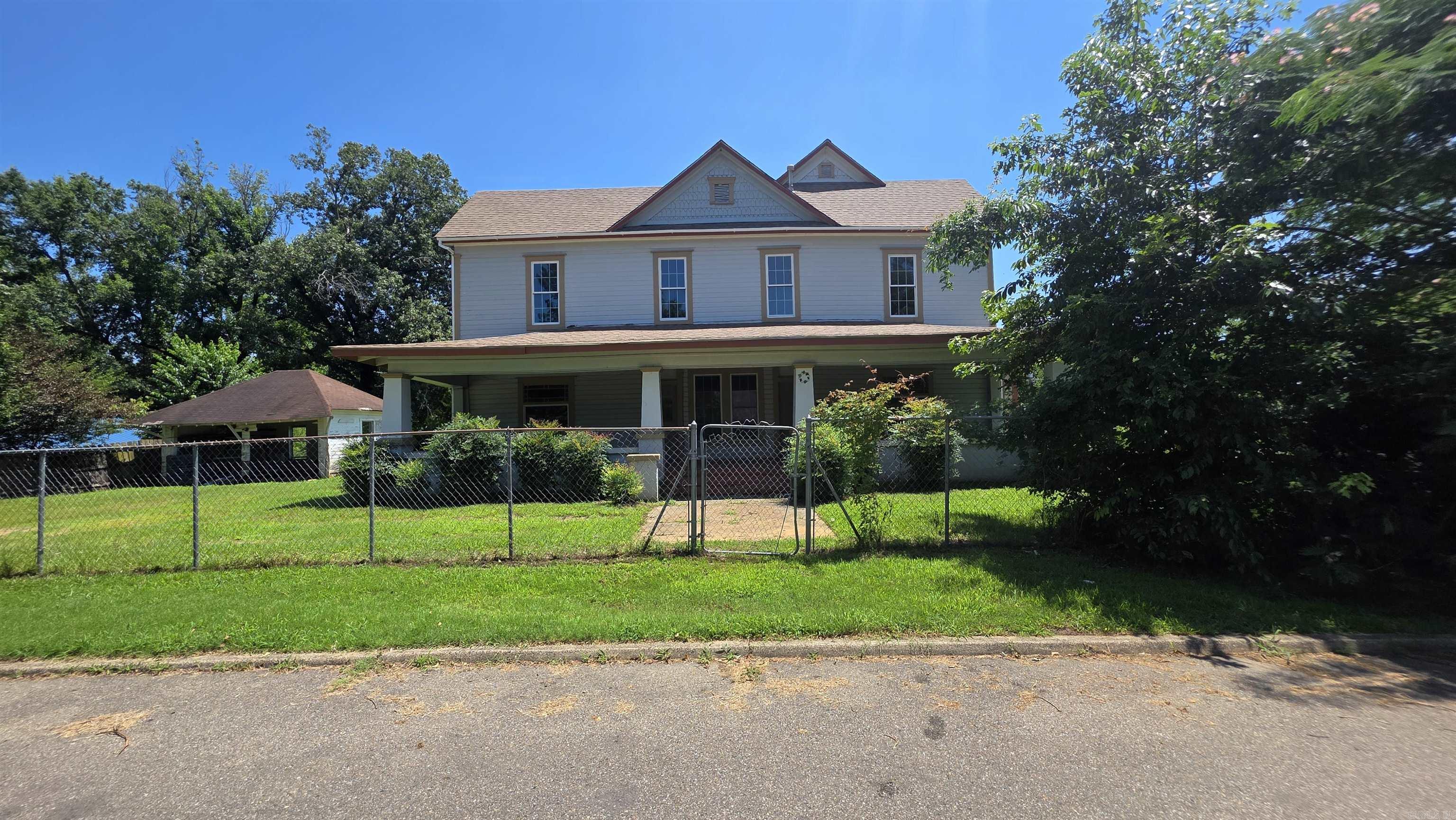 This home was built in 1910!  Still has a lot of the charm of days gone by.  There is 2354 square feet with 4 bedrooms with 2 bonus rooms, large laundry room, and 2 bathrooms!  The roof is new and 22 windows have been replaced. Several rooms have been recently painted and new floor covering put down.  Nice front porch to sit on and enjoy life.  Plenty of room for a large family!  There is a storm shelter close to the back door.  Sits on a large city lot--a little over 1/2 acre!