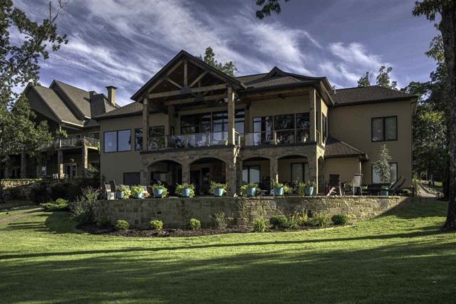 This exquisite custom waterfront residence offers magnificent architectural detailing.  The home's massive beams, stone archways and soaring heights frame exhilarating views through windowed lake-facing walls-even the upstairs veranda's glass railing was designed so as to not interrupt sightlines. Native stone quarried in Lamar, Arkansas sets the tone for rustic authenticity.  Separate office and craft room plus an outdoor living area with fireplace!