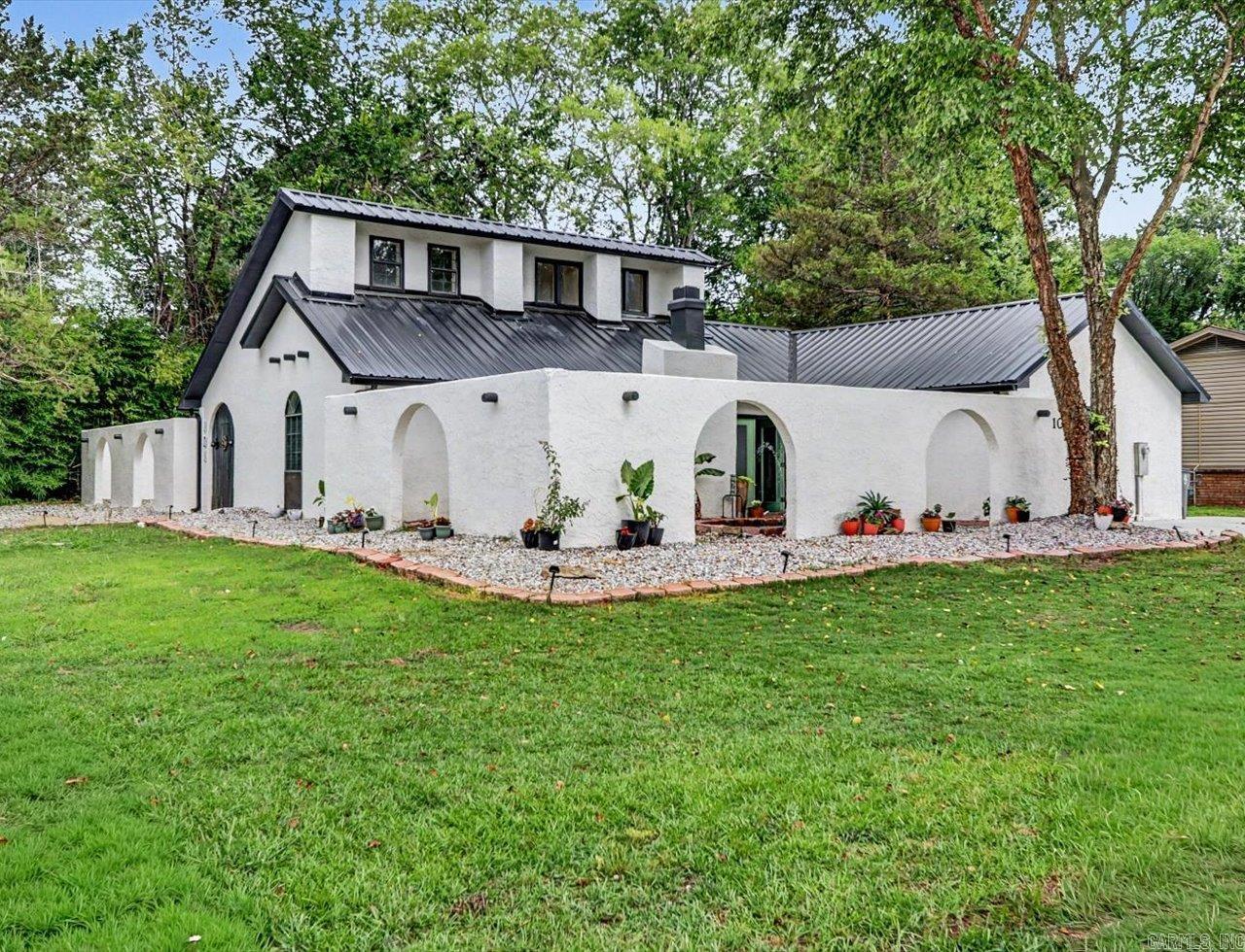 This one-of-a-kind Spanish-inspired home in the highly desirable Lakeside area of Hot Springs. Offering 3 bedrooms, 2.5 bathrooms, and approximately 2,230 square feet, this beautifully updated residence blends timeless architectural character with modern comfort.  Behind the striking stucco walls and custom archways, you'll find inviting living spaces featuring original Spanish tile accents, a cozy fireplace, abundant natural light, and new flooring throughout. The kitchen has been refreshed with new appliances, while recent improvements include fresh interior and exterior paint, updated lighting, door hardware, bathroom fixtures, electrical upgrades, new gutters, and a serviced HVAC system with professionally cleaned air ducts.  The spacious primary suite features a relaxing jacuzzi tub enhanced by an updated skylight with a new privacy shade. Upstairs, flexible bonus space offers endless possibilities for a home office, media room, guest space, or hobby area.  Designed for indoor-outdoor living, the property centers around multiple private courtyards, covered patios, and a beautifully refreshed koi pond. Mature trees, updated landscaping, solar accent lighting, and courtyard enha