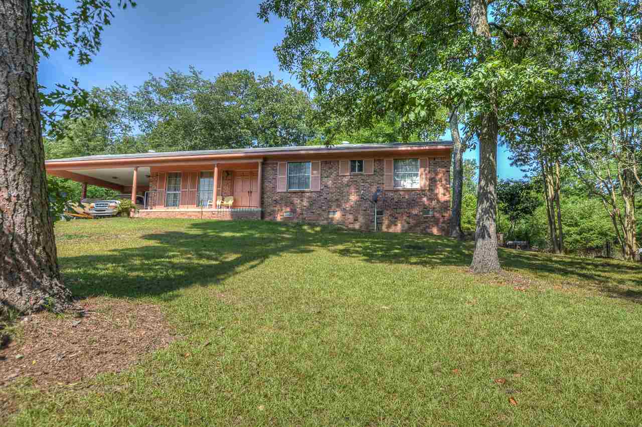 The Good Life begins at home in this 3 bedroom Ranch-style home in a great little neighborhood in the Lakeside school district. The home is perched on the hillside sitting at the end of the street next to the woods.  Offering hardwood flooring throughout, a sunlit hearth room with a wood-burning fireplace, a breakfast patio, and a 2-car carport.  The back yard is fenced and has some old beautiful natural stone walkways lined with irises and mature shade trees.