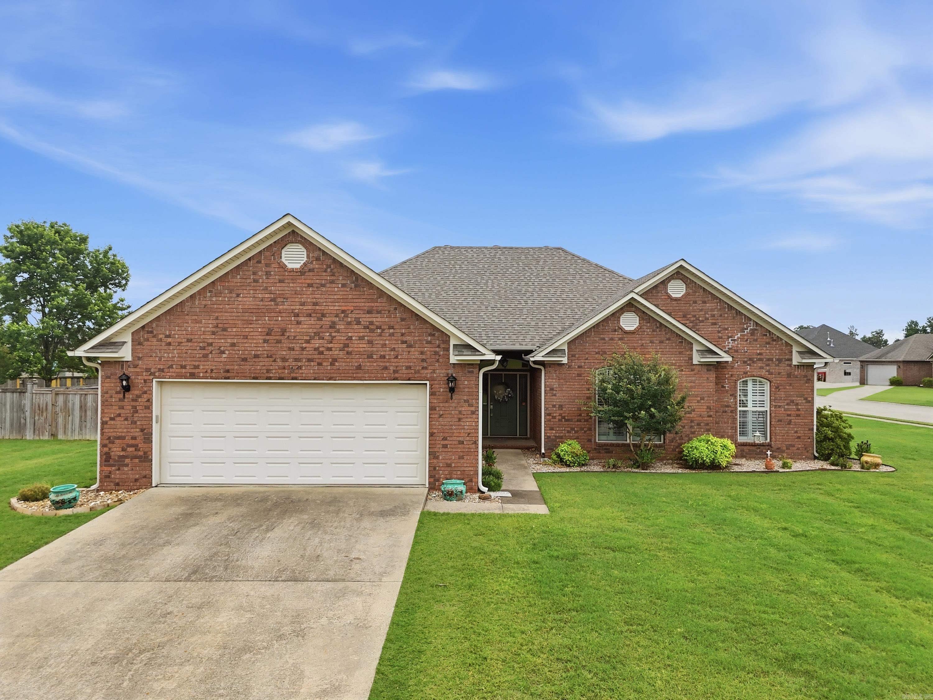 THIS CHARMING HOME SITS ON A CORNER LOT IN QUAIL HOLLOW SUBDIVISON. IT IS MOVE IN READY AND NOT YOUR TYPICAL COOKIE CUTTER HOME. THE ROOF WAS REPLACED IN AUGUST OF 2023, HVAC 2019, WATER HEATER IS NEWER AND DISHWASHER, REFRIGERATOR AND MICROWAVE WERE JUST PURCHESED IN 2026. SPLIT BEDROOM PLAN WITH THE PRIMARY BEDROOM HAVING ITS OWN SITTING AREA. LARGE CLOSET AND PRIMARY BATH. THE KITCHEN HAS PAINTED CABINETS AND TWO EATING AREAS WHICH ONE COULD CERTAINLY BE USED AS A SECOND LIVING SPACE. THE HEATED AND COOLED ATTACHED SUNROOM WOULD MAKE A GREAT OFFICE, PLAYROOM, WORKOUT SPACE OR USE AS ADDITIONAL LIVING SPACE. TWO SECONDARY BEDROOMS SHARE A SPACIOUS HALL BATH. THERE IS ALSO A HALF BATH OFF OF THE ENTRANCE FROM THE GARAGE. NO CARPET TILE AND WOOD FLOORING THROUGHOUT. THE FULLY FENCED YARD HAS A LARGE GATE FOR THE FRONT BUT AN ADDITIONAL GATE COULD BE ADDED TO THE SOUTH SIDE FENCE. MAKE AN APPOINTMENT TO SEE THIS LOVELY HOME, WHICH IS MOVE IN READY.