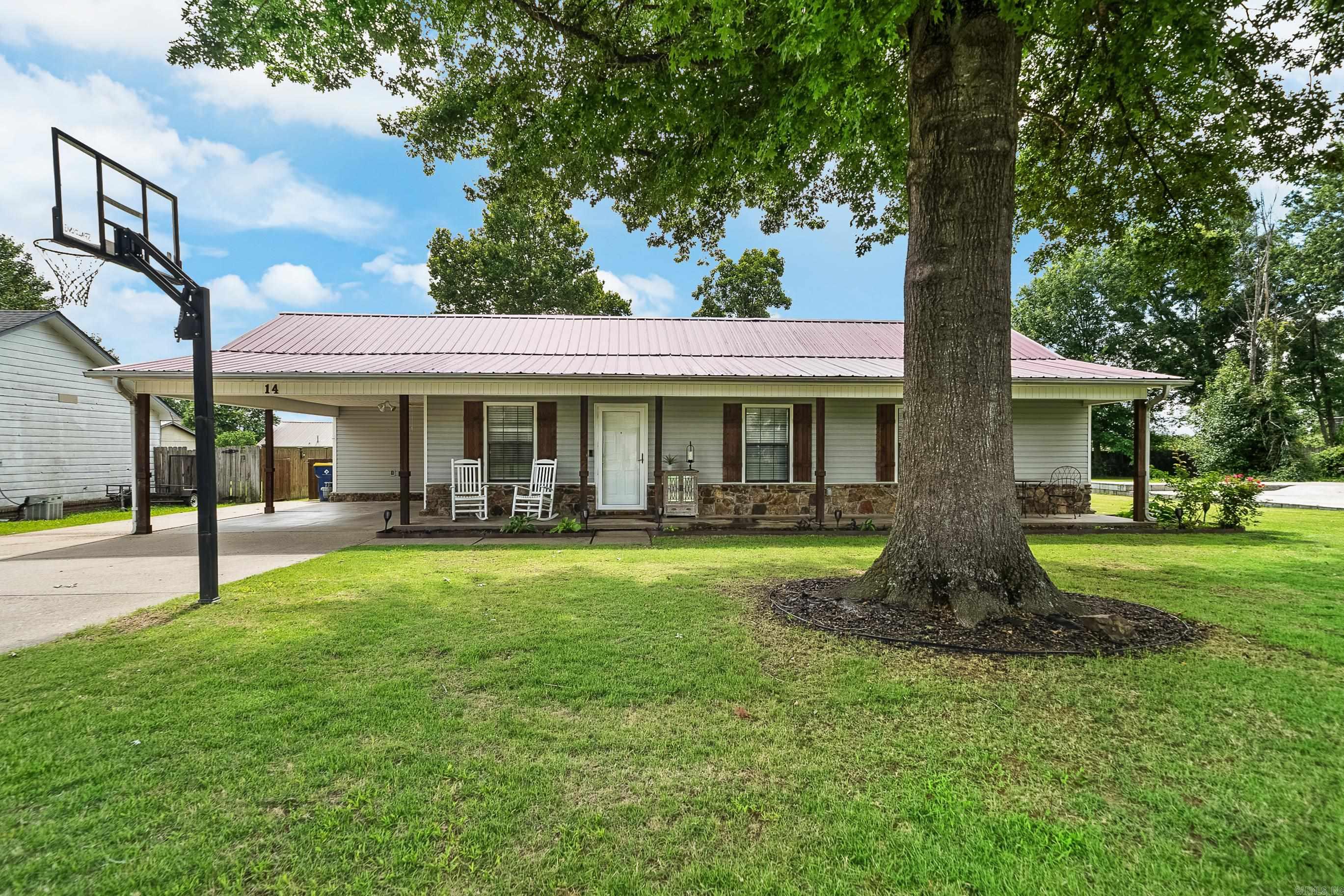 Welcome home to this charming 3-bedroom, 2-bath home that blends comfort, functionality, and outdoor living! You'll love the inviting front porch, perfect for rocking chairs and morning coffee beneath the shade of the mature trees. Inside, you'll find updated finishes and a beautifully remodeled bathroom that adds a modern touch to this cozy home.  Outside is where this property truly shines. The spacious backyard is fully fenced and features an above-ground pool ready for summer fun, a storage building for all your tools and toys, and a covered back patio that's ideal for grilling, entertaining, or simply relaxing after a long day. Need extra parking? The extended driveway provides plenty of room for multiple vehicles, guests, a boat, or recreational equipment.  A durable metal roof offers peace of mind and long-term value, while the established neighborhood setting makes this home one you'll want to see in person. Whether you're hosting pool parties, enjoying quiet evenings on the porch, or looking for practical features that fit your lifestyle, this property checks all the boxes.  Don't miss your chance to make this move-in ready gem your next home!