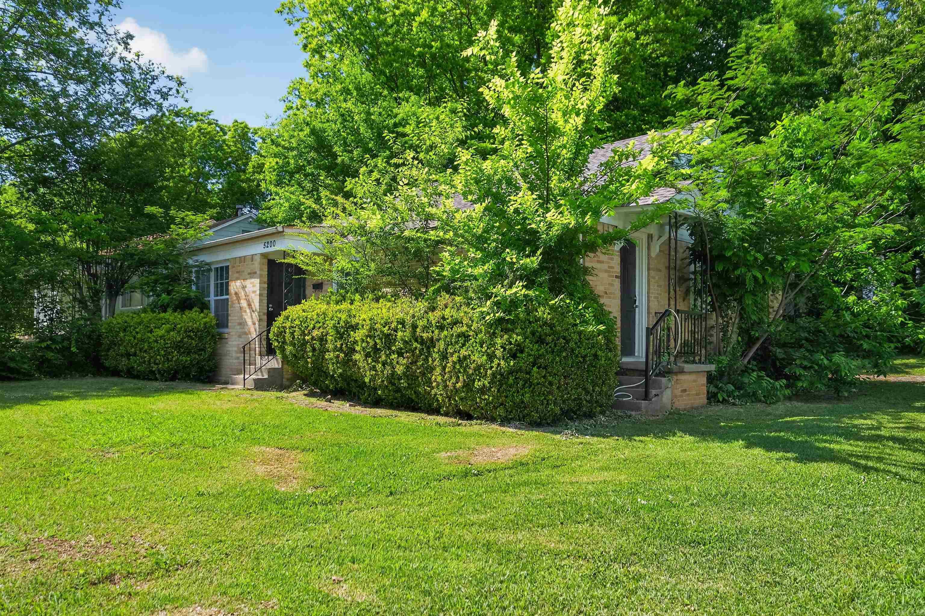 Charming 2-bedroom, 1-bath home in the desirable Oakwood neighborhood, just minutes from Fair Park and the UALR revitalization area. Positioned on a spacious corner lot, this property offers ample outdoor space and a welcoming feel. Inside, you’ll find warm wood flooring throughout, updated double-pane windows for efficiency, and a thoughtfully designed kitchen with modern upgrades and plenty of sunlight. A dedicated laundry area adds convenience, making this home a perfect blend of character and everyday functionality.