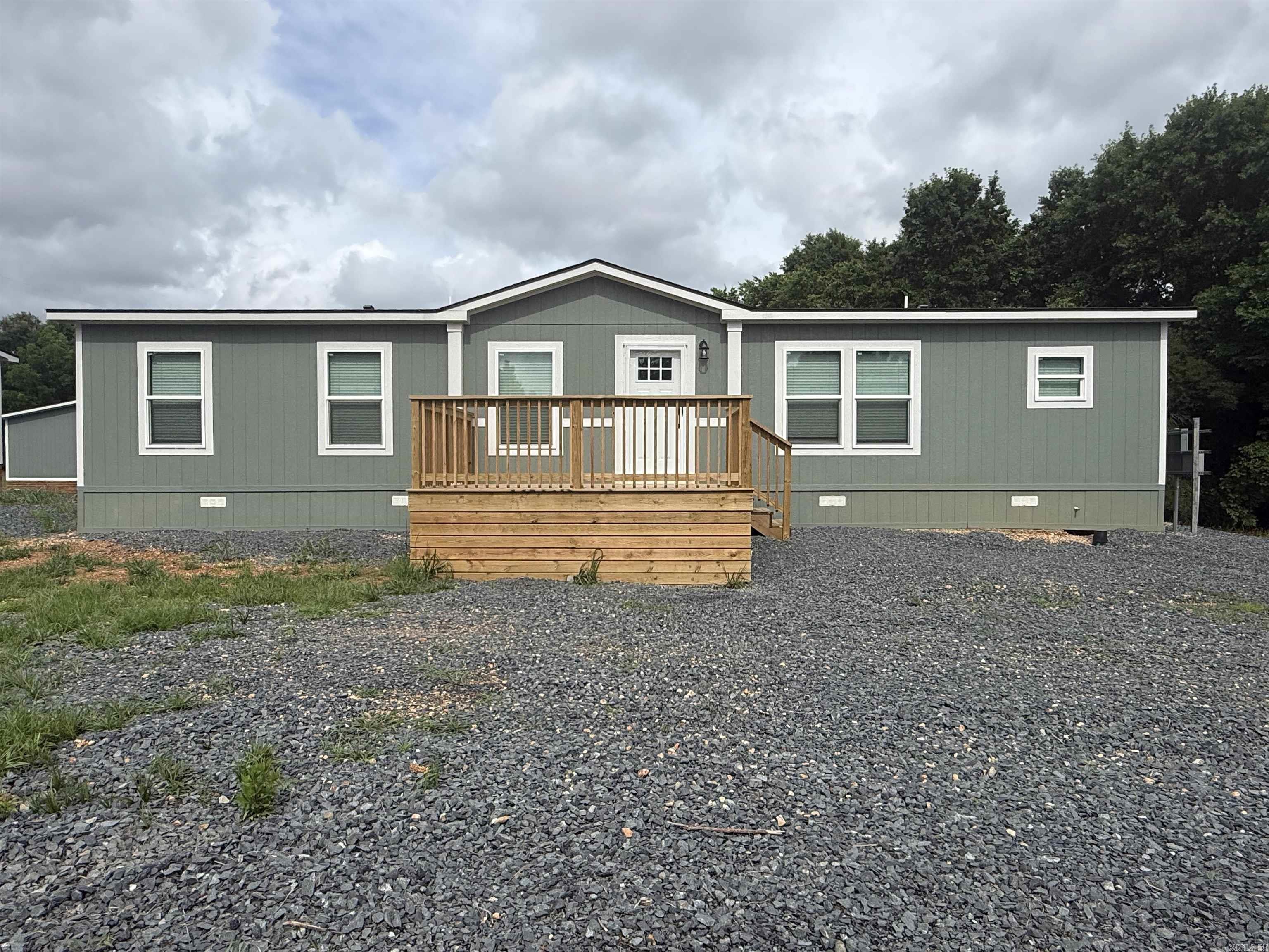 2025 3-bedroom, 2-bathroom manufactured home with approximately 1,568 sq ft, featuring warm farmhouse finishes and a bright, inviting interior. This thoughtfully designed open floor plan offers a spacious living area, oversized kitchen island, stainless steel appliances, light cabinetry, and natural wood-tone accents throughout. The split-bedroom layout includes a private primary suite with a walk-in closet and an ensuite bath. Modern lighting, neutral colors, and comfortable living spaces make this home feel both stylish and welcoming. Permanently affixed to the ground on a concrete slab, making it eligible for government financing per engineering certification requirements. Brand new and move-in ready! See documents on file for a copy of the Energy Star Certification.