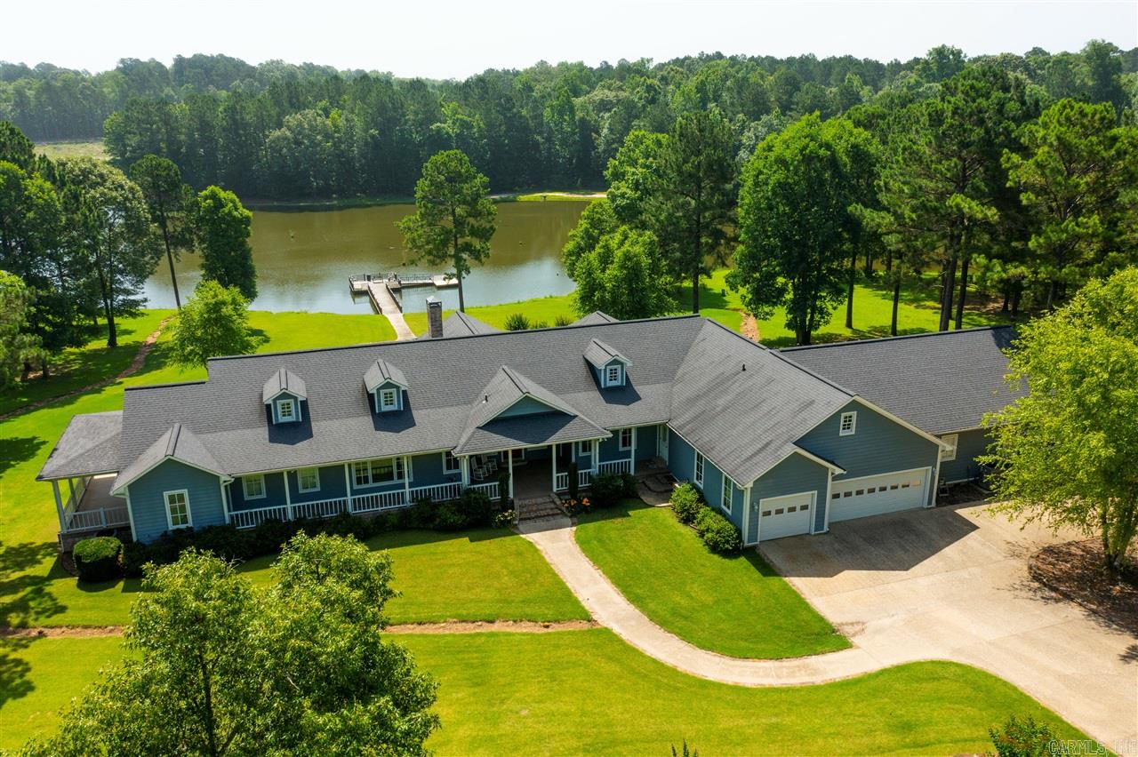 Click the external link below to tour this home now!    Large, upscale, contemporary style home. Built in 2011 by Barry Cameron. Home is situated in both El Dorado and Parkers Chapel School Districts. Property includes 5213 square foot home, two-story detached matching shop and 5 Acre lake stocked with largemouth bass and bream. Home is surrounded by John Watson moonlight effect tree lighting with 55 light fixtures that enhance night time charm and security.    Also included with the property is a 3 bedroom/2 bath 2005 manufactured home with a detached matching shop. This property sits on an additional 3 acres and is renter occupied.