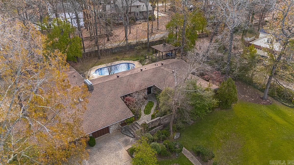 Welcome to this stunning one level rock home offering 3,825 sq ft of beautifully designed, open-concept living space. Perfect for everyday comfort and grand-scale entertaining, this property boasts massive room sizes throughout, including a huge separate dining room that could easily serve as a game room or secondary living space.  The versatile floor plan features 4 spacious bedrooms, 3 full bathrooms, and a conveniently located half bath just off the garage—ideal for quick access when working outside. Complete with premium tile and luxury vinyl flooring and carpet.  Step out back into your own private backyard oasis situated on a level 0.56-acre lot across the street from golf course. The outdoor amenities are unmatched: a sparkling inground pool, a charming gazebo perfect for relaxing in the shade, and a dedicated half-court basketball court for sports enthusiasts. Step out of back yard onto a walking trail. Complete with a 3-car garage and exceptional landscaping, this Maumelle gem truly has it all. Schedule your private tour today!