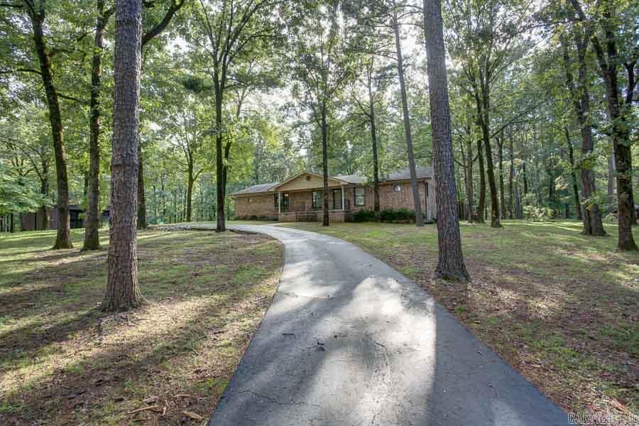 Perfect spot to build a custom home in the woods or for development! 2 parcels: 2.66 & 39.89. Smaller plot has a lovely 1 level private home w/ Pella windows & sliding doors. Heated & cooled sunroom looks onto a nicely manicured Koi Pond. Site finished hardwood throughout most of home. Split floorpan. Newer GE full house propane generator. 40x50 shop with two 12 foot automatic bay doors, water, electric & security. 2nd shed on property. 40 acres has mature timber and separate access through Crystal Lane.