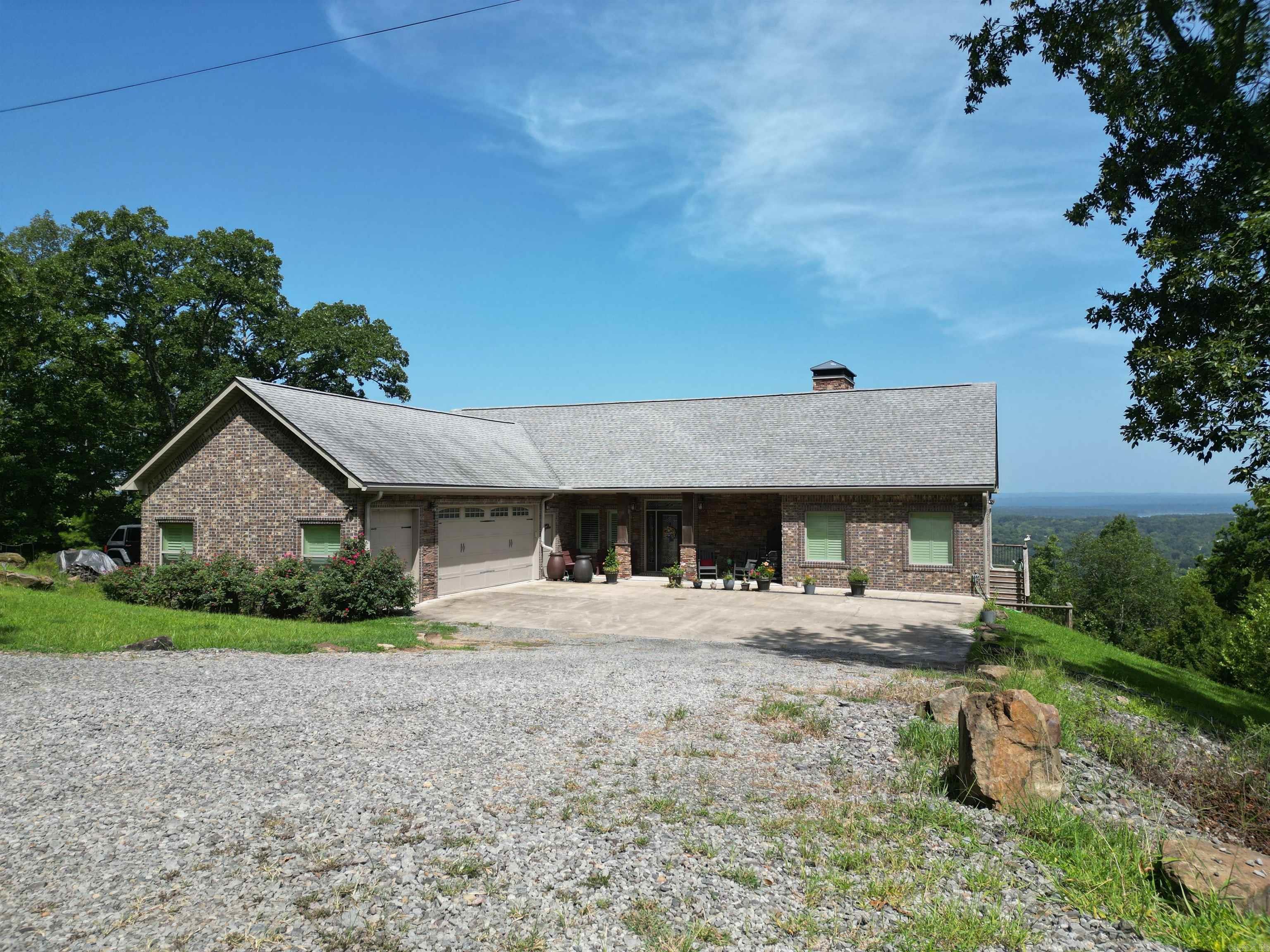 Breathtaking Views of Greers Ferry Lake & Heber Springs. Every room in the house captures the view, making it hard to look away. Custom-built home on 7.19 acres, with frontage on the subdivision pond, 30 x 40 shop building, whole house generator, 3 water wells, vegetable garden & fire pit area.This home features open living, spacious screened porch, 2 woodburning fireplaces, vaulted ceiling, fantastic closet & storage space. Walkout basement family room, custom bar w/live edge countertop, bedroom , full bath, storm room & oversized utility room w/plenty of room for extra refrigerator & freezer. If you are looking for a quality home with the feel of quiet peace & privacy, incredible views & self sufficient this home is for you. Heber Springs only 2 miles away.