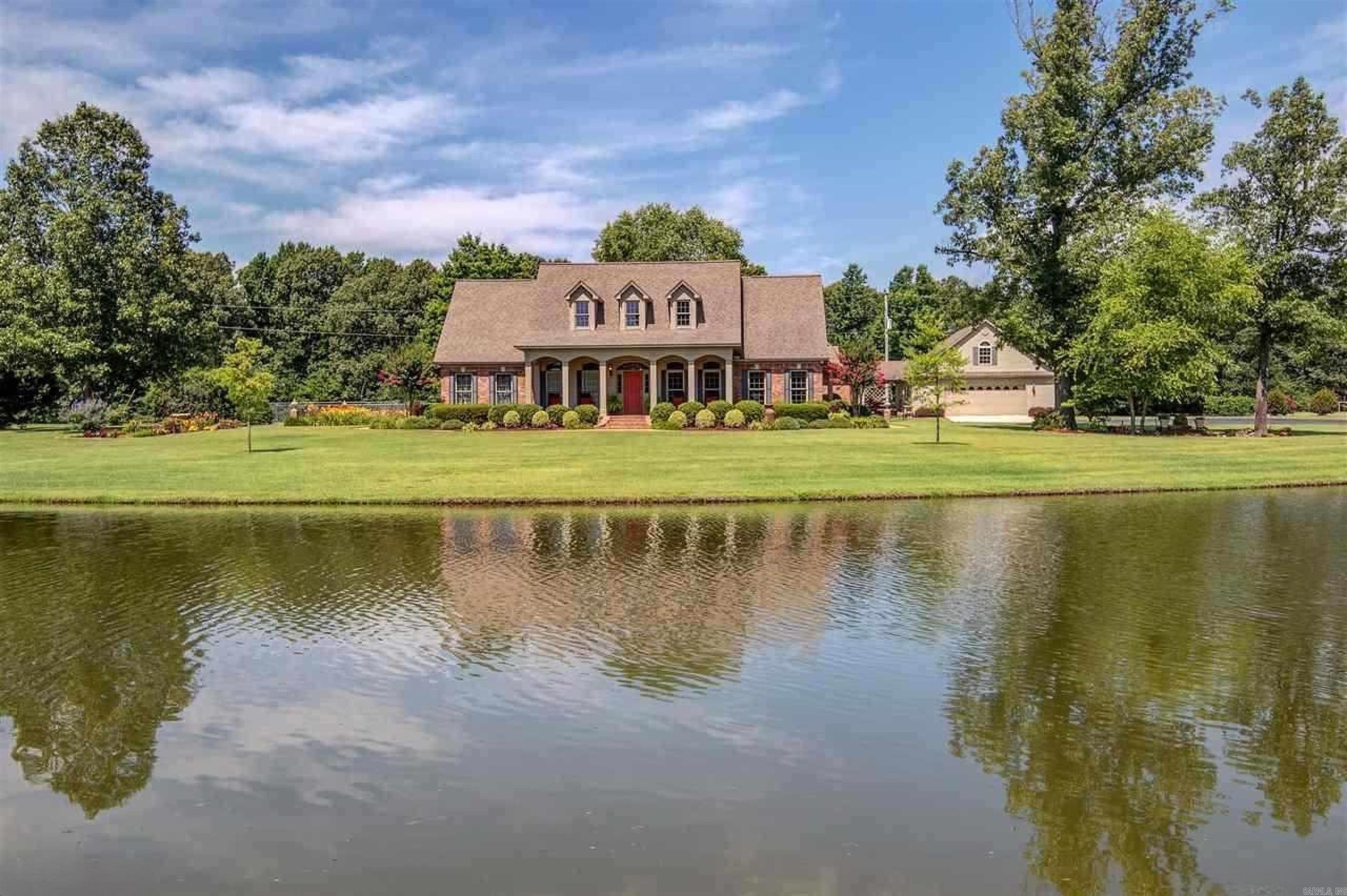 Welcome to an expansive and beautifully maintained 33± acre retreat with great income stream from overnight horse boarding business.  This property features a private stocked pond, trophy deer hunting, and two custom homes. The main residence offers 3 bedrooms plus bonus rooms; the second home includes 2 bedrooms and an office. Enjoy exceptional landscaping, orchard, greenhouse, shade house, gardens, multiple outbuildings, and ample space for livestock or expansion. Property includes several temperature-controlled garages and a large climate-controlled shop with its own bathroom and laundry—ideal for an on-site business. SEE IT TO BELIEVE IT! Both homes are equipped with commercial-grade whole-home generators, 39 kWh solar, 108 kWh battery backup, and a private well system, providing near off-grid capability. A 60x60 horse barn features 10 stalls (8 inside and 2 outside) office, restroom, and multiple LQ hookups. With robust infrastructure and a well-established turnkey business already in place, this property offers exceptional versatility. Front acreage also offers potential for commercial opportunities.