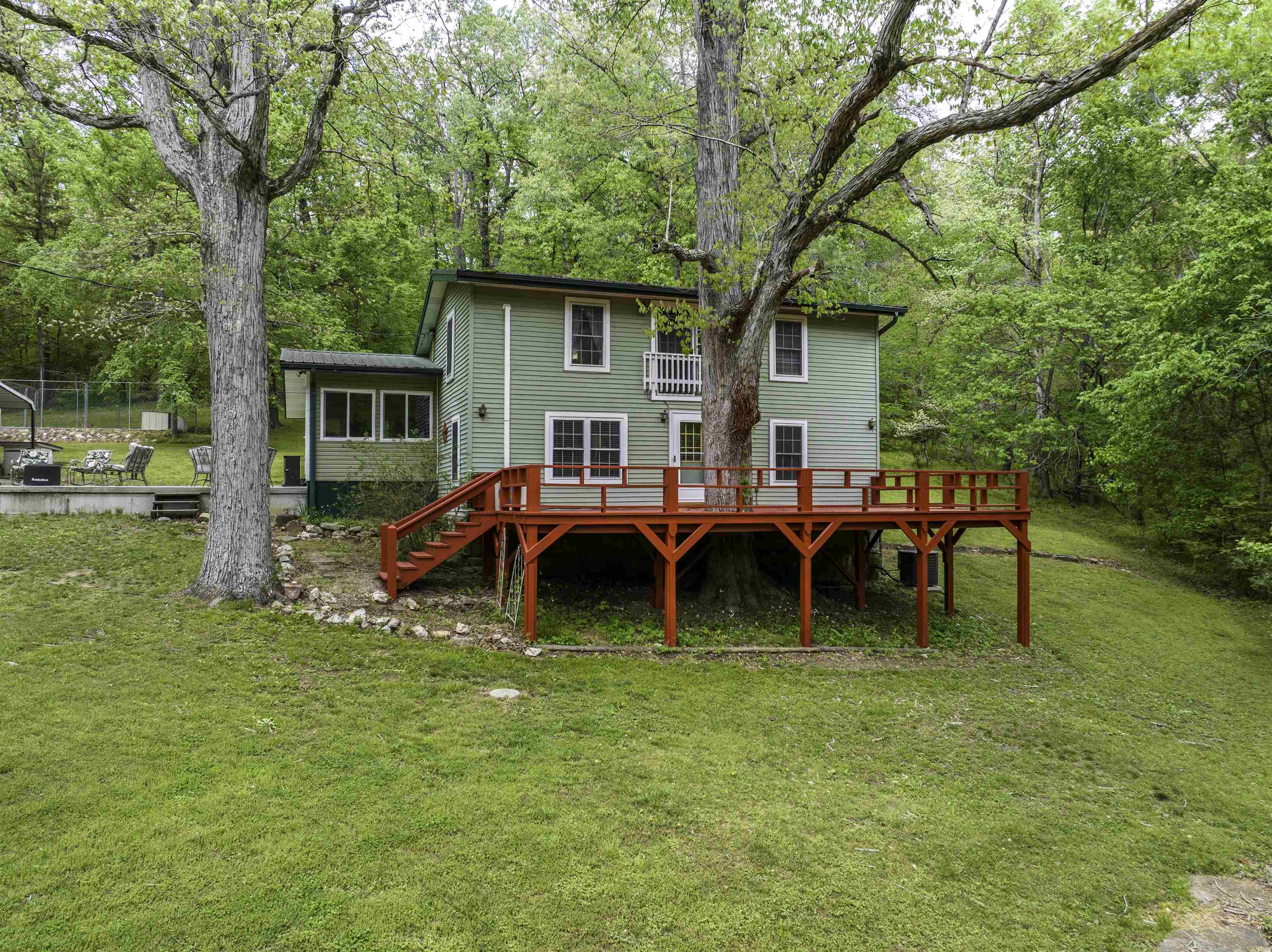 Country Home - Nestled on 5 beautiful ac with approx. 1,000 ft of Wells Creek, this well-maintained country home offers the kind of setting buyers are always hoping to find. The 1,680 sf home features 2 bed and 2.5 ba and is perfectly positioned above the creek, out of flood danger, so you can enjoy the water without the worry. Surrounded by large white oak trees that provide generous shade, the home has a welcoming large front deck where you can relax and take in the peaceful views. There is also a nice patio area, a 2-car metal carport, and several pecan trees that add even more charm to the property. The land is especially appealing, with a very gentle lawn that slopes down toward the creek, making access easy year-round. Whether you enjoy fishing, wildlife watching, or simply soaking up the quiet beauty of nature, this property delivers. Deer and turkey are frequent visitors, and the variety of birds, a true outdoor lover’s retreat. 36’ x 36’ barn adds excellent function and flexibility, whether you need storage, workshop space, or room for equipment and hobbies. A 36’ x 36’ barn adds function and flexibility. This is a rare opportunity to own a scenic creekside property.
