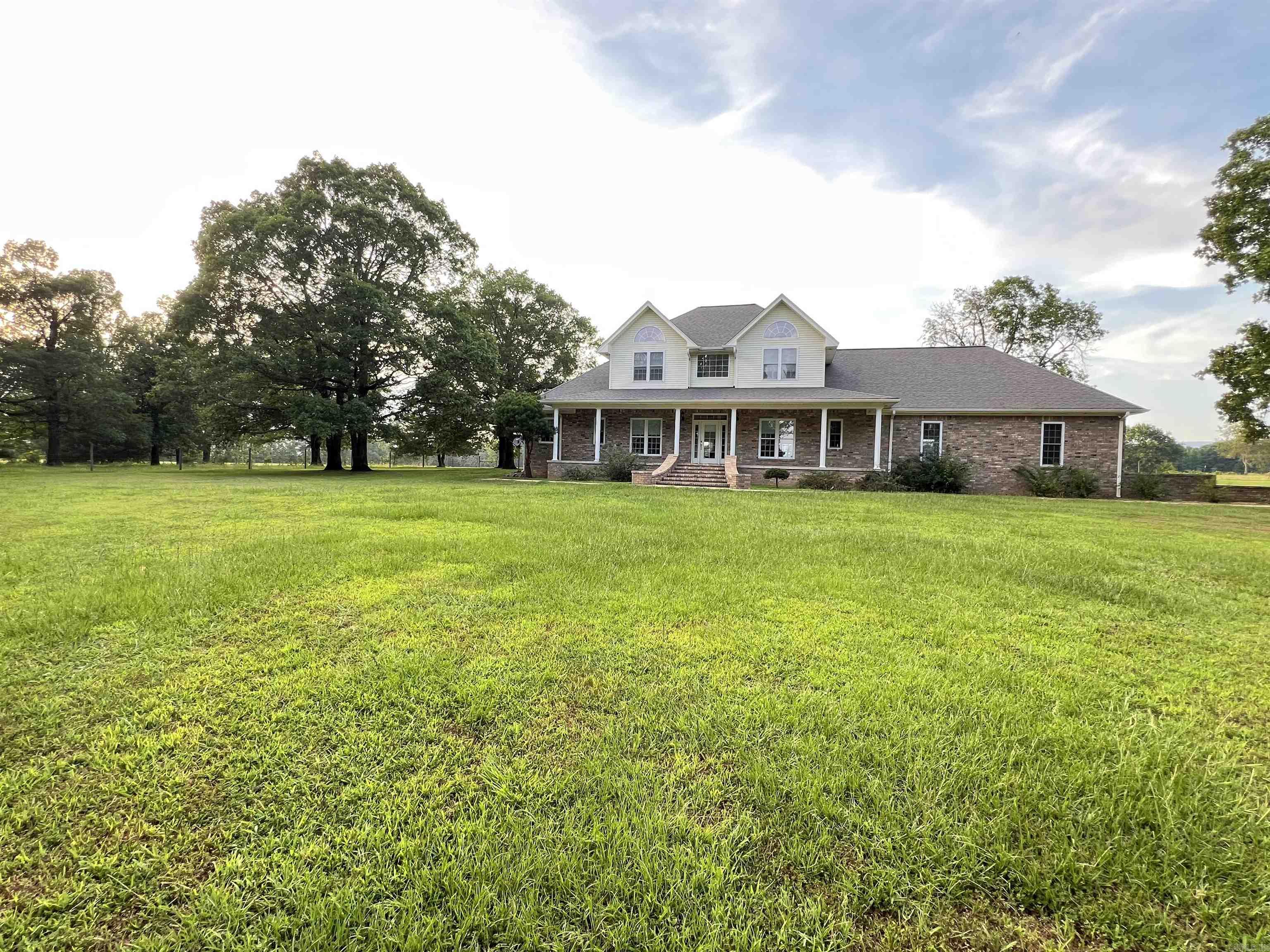 Looking for your dream home?  This classy custom brick home sits on 248 acres with the perfect blend of cross fenced pastures and trees! The open floor plan features new laminate flooring throughout the lower level, Fresh Paint, NEW A/C unit, 18 ft. ceilings, built in oak book cases and cabinets, double hung windows, and a pellet stove with 20+ bags of pellets. The kitchen boast a double oven, a wall oven, a stunning blue sink, and plenty of cabinets! The pantry/laundry room is equipped with a double sink, tons of storage, BRAND NEW refrigerator, and a full bathroom!  The primary suite is on the main floor, with 3 bedrooms on the lofted second floor. Additional features include a formal dining room, breakfast dinette, office/piano room, 2 soaking tubs, whole home backup generator, a NEW security system, and a large 3 car garage. The home is being sold fully furnished, and includes some beautiful pieces!  Step outside to the POOL and enjoy views of RICH MOUNTAIN as you relax.  This secluded acreage includes 5 ponds, a hay barn, and a shop for equipment. This unique property has been enjoyed and adored by its original owners for decades. Don't miss out on this one of a kind oasis!
