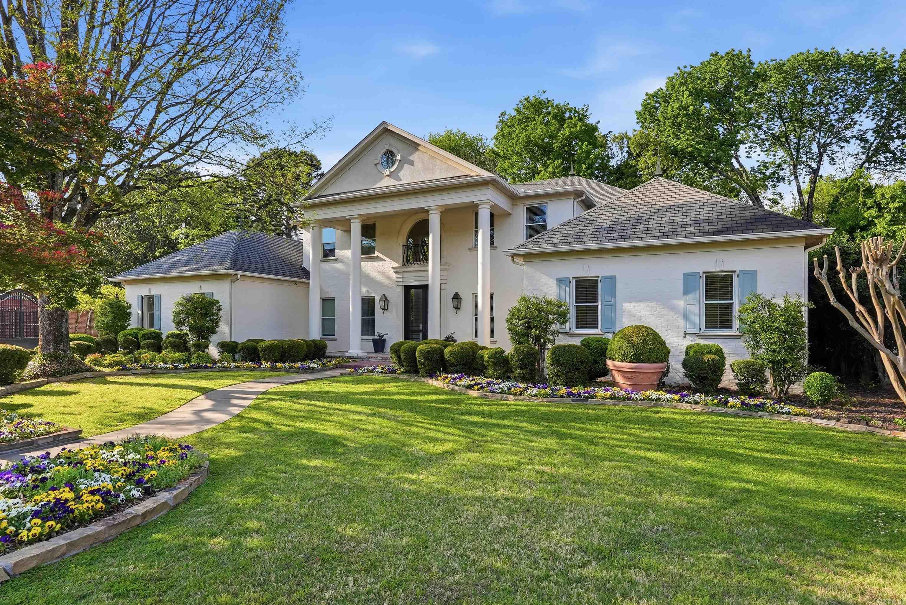 Stunning Georgian residence on a quiet cul-de-sac behind the gates of the coveted Hickory Creek neighborhood. With over 4,800 square feet on the main level, this home offers exceptional scale, timeless design, and a versatile floor plan ideal for both everyday living and entertaining. The foyer features a 20-foot ceiling and sweeping curved walnut staircase. Spacious great room with custom hand-carved marble fireplace mantel, spacious dining room, inviting den with built-ins, and sunroom with fireplace overlooking the brick-fenced yard. Remodeled gourmet kitchen includes new countertops, backsplash, stainless appliances, GE Monogram gas range, convection microwave/second oven, built-in refrigerator and freezer, and KitchenAid ice machine. Two primary suites, including a luxurious main-level suite with new marble flooring and renovated bath with heated floors. Upstairs offers four additional bedrooms with direct bath access and walk-in closets. Additional features include: fresh paint throughout, 8-foot solid doors, gated drive, two refreshed bathrooms upstairs and a three car side-load garage with new doors and openers.