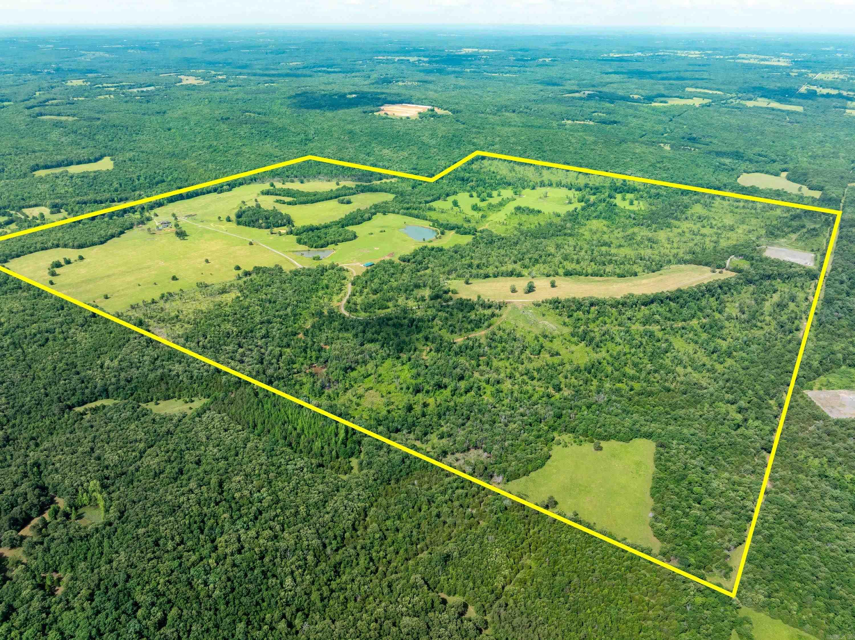 614 +/- Acres, 2 houses, one being built in 2024 having 2 bedrooms and 2 baths and about 2,000 sq ft with the other having 3 beds, 3 baths and about 3,000 sq ft along with a shop out back.  This farm has a cattle corral, its fenced, cross fenced, has Piney creek running through it, has 11 ponds, has 500 gallon automatic waterers, can run about 200 cattle on land.  Current seller runs about 130 head of cattle and does rotational grazing.  This is an exceptional farm ready for a new family to take over this legacy. No mineral rights to convey because seller does not own them.