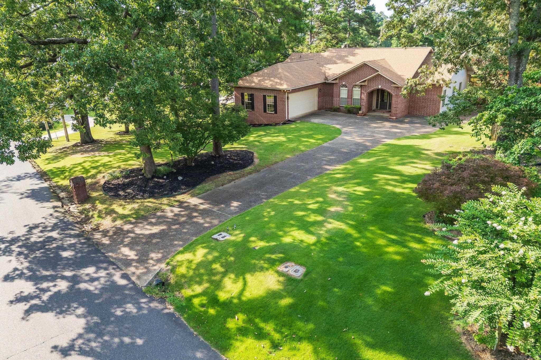LAKESIDE SCHOOLS W/LAKE HAMILTON VIEWS across the street from Million $ homes + LAKE ACCESS  is a very nice one-level 3BR 2.5 BA brick home!  The floor plan features a sequestered Master Suite with separate shower, jetted tub & walk-in closet, the Dining Area and Family Room feature a cozy gas log fireplace, wet bar and hardwood floors opening to an efficient Kitchen with Bar & Breakfast Nook. There are 2 additional Bedrooms, 1 1/2 Bathrooms,  a Laundry Room and an abundance of storage.  The entire house has been freshly painted and new carpeting in bedrooms + fixtures.  Enjoy an oversized side-entry two car garage, your privacy fenced back yard and a covered porch to enjoy the outdoors; a Lake Hamilton Access lot is exclusive for use by Tanglewood residents to launch your water craft!