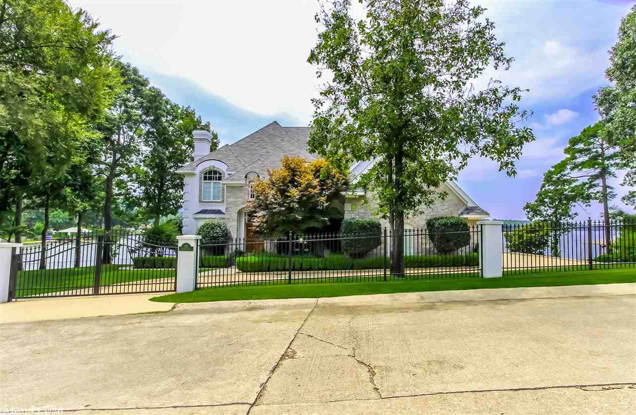 Beautiful home in gated Driftwood Subdivision.  This custom home, which sits on two manicured lots with wrought iron fence, gates and a fabulous view, is made for luxurious living and entertaining.  It features hardwood floors, spacious bedrooms, formal dining room, formal living room/den, office/5th bedroom.  Just wait til you see the awesome gameroom with pool table room, sitting area, wet bar and cozy alcove.
