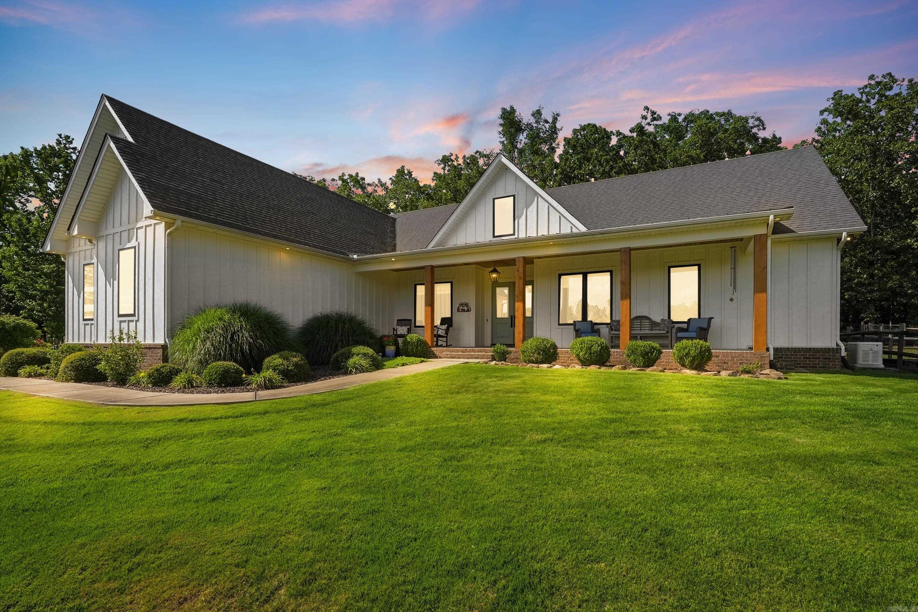 20 private acres. Custom modern farmhouse. Gated. NO HOA. Minutes to Conway and I-40. There is simply nothing else like this on the market. This 4 bedroom, 3 bath home is more of a retreat that blends luxury, privacy and functionality with breathtaking views, mature trees, luscious zoysia grass, abundant wildlife, a screened porch with fireplace, and a 30x40 barn complete with water and electricity. Inside this beautiful home you'll find 10 ft ceilings throughout, two spacious living rooms (each with their own fireplace), Andersen Fibrex windows, custom millwork, handcrafted barn doors, a safe room, and a Generac whole-home generator that automatically powers on during outages for added peace of mind. This home has it all and is a rare combination of exceptional craftsmanship, acreage and convenience. Schedule your private tour and make this gorgeous property your next home before someone else claims it. Agents see remarks.