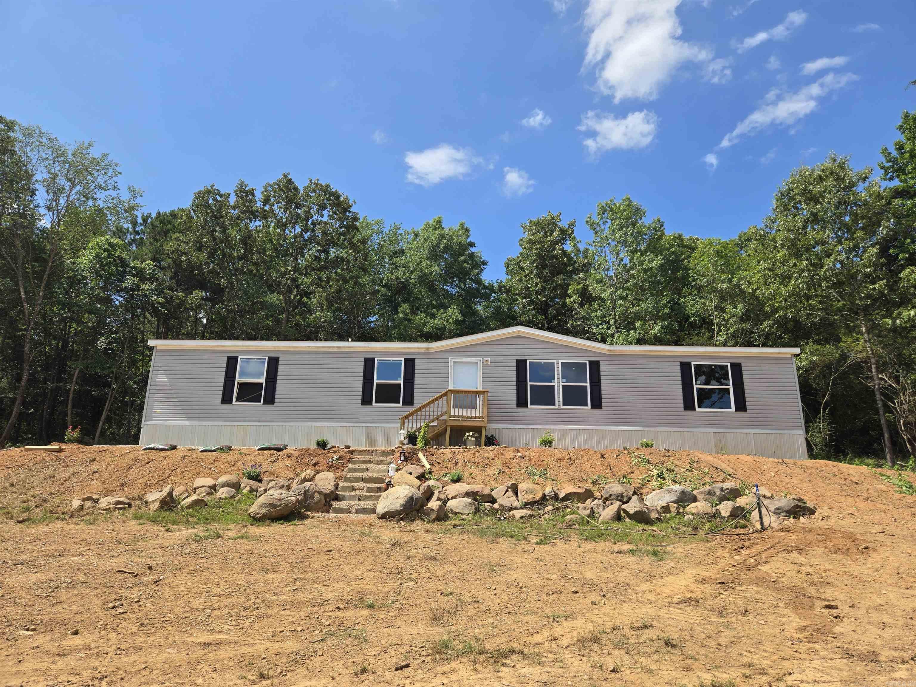 New Champion Manufactured home installed on approximately 6.5 Acres in between Perryville and Lake Nimrod in Arkansas, Bordered by Deltic Timber in the back & Approximately 15 minutes from the Lake! 12 minutes from Town!  Beautiful Country Setting in Arkansas with a 4 Bedroom 2 Bath home set on a permanent foundation. NO Restrictions!  Utility Services will include: New City Water Line, New Septic System, High Speed Internet or Fiber Internet & good cell coverage!