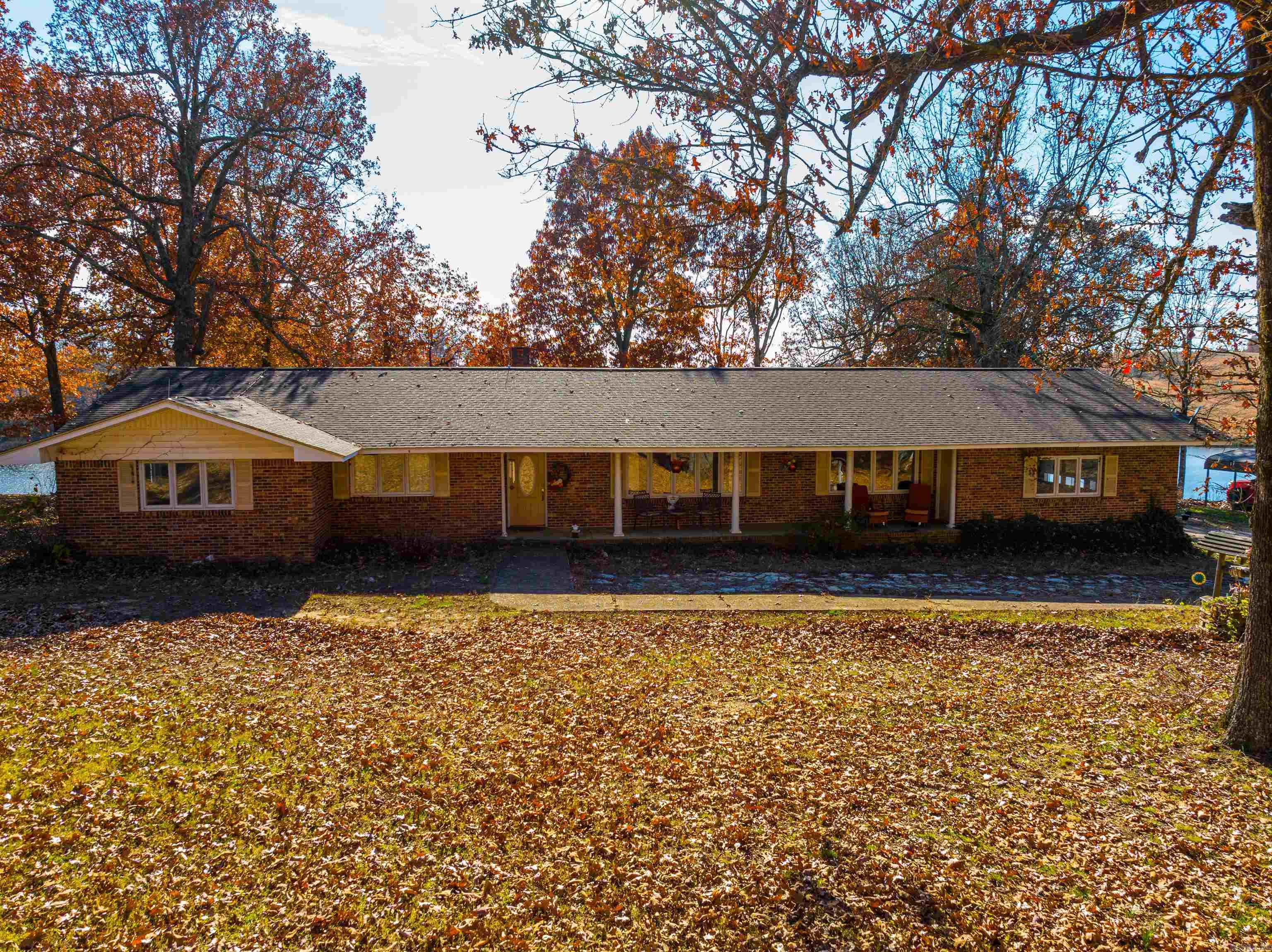1,242 +/- Working Cattle Ranch that includes a home overlooking a 15 +/- Acre Lake called Bulls Eye Lake, 20 + Ponds, a guest house, a large shop, several machine sheds, a hay barn, all fenced, cross-fenced, gated entrance, over 700 acres is pristine pasture, creeks, springs and then you have the start of the Strawberry River running through the property!So, this property is located in the Ozarks of Fulton County, Arkansas, just a few miles north of Ash Flat and a few miles south of Mountain Home.This ranch is secluded but not far from town, Walmart, hospitals, doctors, etc.machine sheds and hay barns, which are up by the coral and working pens.Great setup, move your cattle in and start running them immediately with grass knee-deep!Fencing, cross-fencing, rolling hills, pasture, hay fields, water sources, timber groves for shade, and vista views?  There are river bottom hay fields, high mountain summertime pastures, marketable timber, every cross fence having a water source, all pastures are large, 80 + acre pastures, working coral is permanent, and there is a 2nd working coral on the north end of the ranch that takes in 4 large pastures with both having head shoots.See more info!