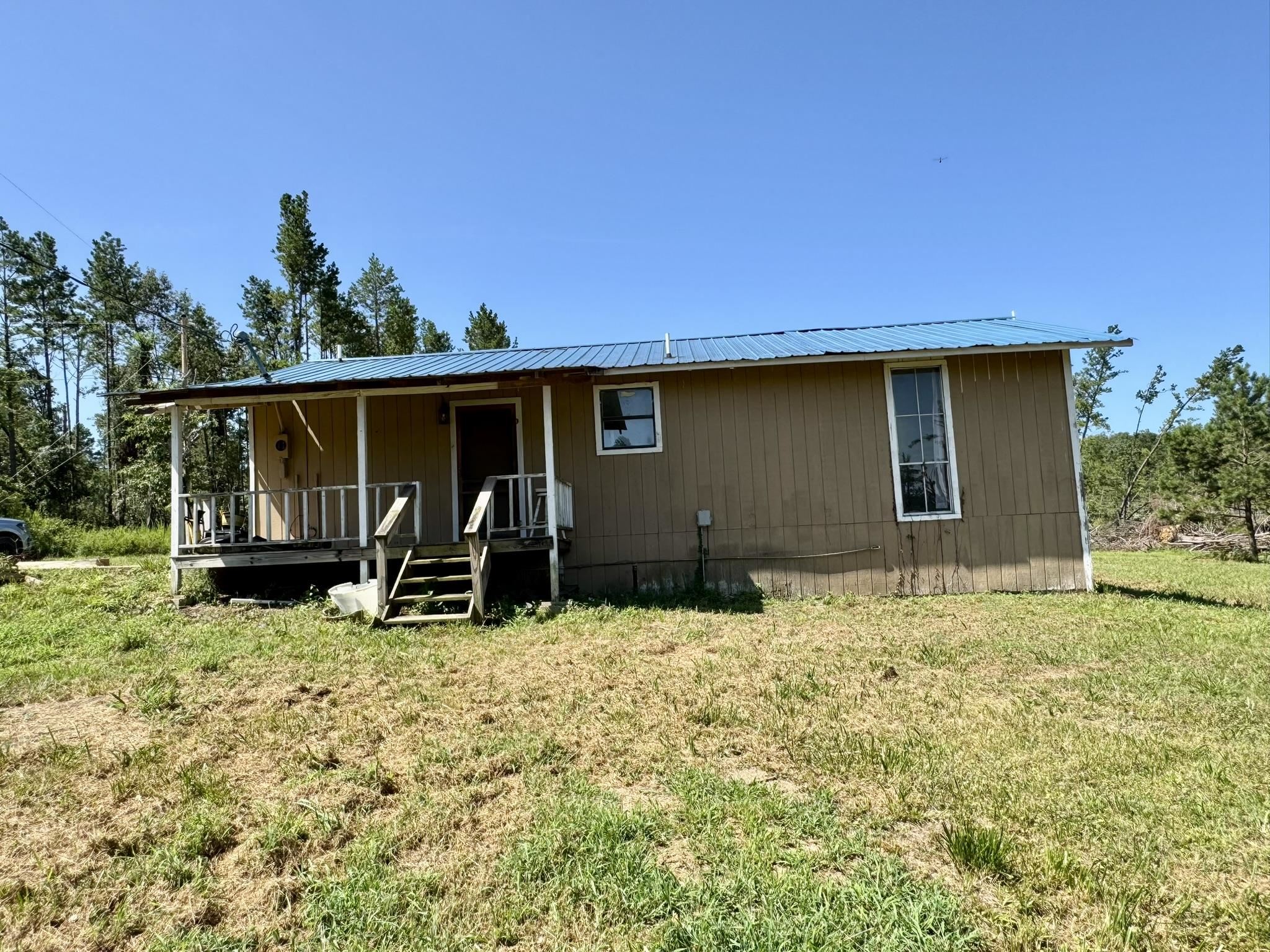 2 Bedroom, 1 Bathroom Home on 5 acres! This property has a large open yard with endless possibilities! Great property for a homestead at an affordable price!  Home has a large kitchen open to the dining room and living area. Two spacious bedrooms, full bathroom, and a large mudroom/laundry room.  Home is being sold AS IS!