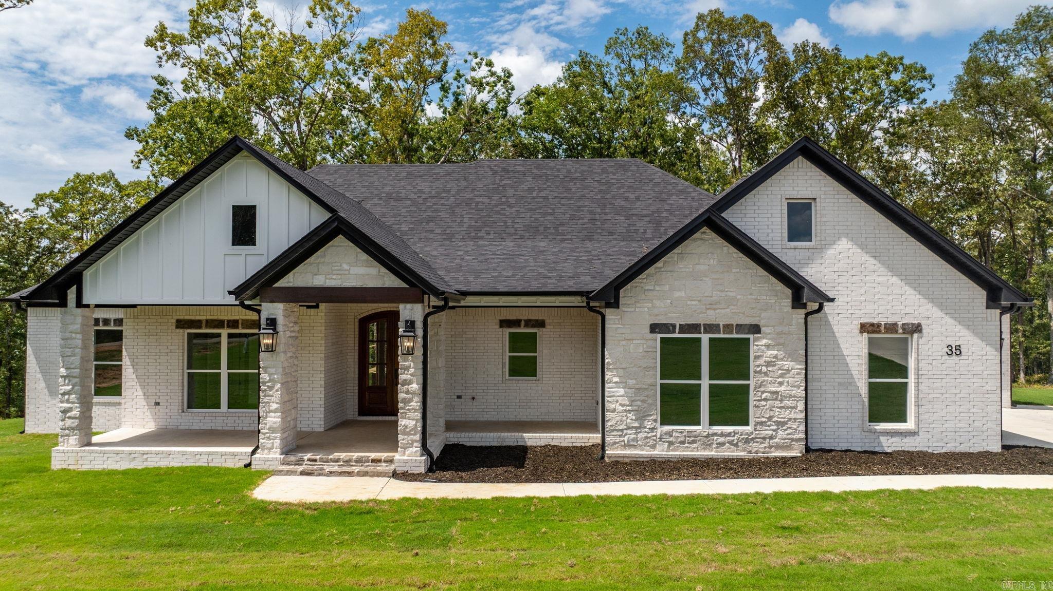 Over one acre Lakefront Lot! Enjoy the views of the lake from the big covered back porch with a vaulted tongue & groove wood ceiling. A large deck will be added for even more outdoor entertaining space. There will be room in this backyard if you wanted to add a pool later. The home is open concept with cabinets in the kitchen to the 10 ft. ceilings. The pantry is huge & will be hidden behind the cabinet doors in the kitchen cabinets. Will have a massive island with the sink in the island. The living room has a vaulted ceiling that carries out to the back porch. You will love the windows with the views of the lake. The laundry is oversized with lots of cabinets. From the laundry room you can enter the primary closet with more room than you will have clothes for. From the closet you can enter the primary bathroom. Separate tile shower & soaking tub and dual vanities. Primary bedroom is separate from the 3 guest bedrooms. Luxury vinyl flooring throughout. Lockers as you come in from the garage. The 3rd bay of the garage is extra deep (35 feet) to stow all of your lake toys and your boat.  There is also room on this lot to build a shop. This subdivision is brand new. All new homes here