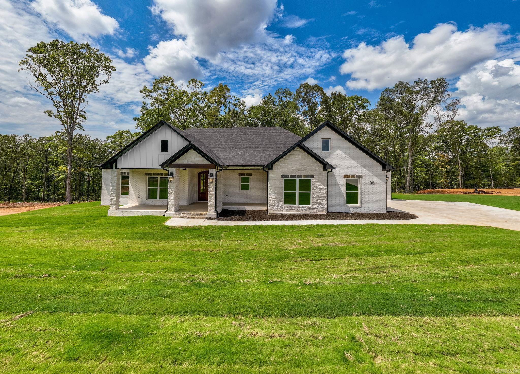 Over one acre Lakefront Lot! Enjoy the views of the lake from the big covered back porch with a vaulted tongue & groove wood ceiling. A large deck will be added for even more outdoor entertaining space. There will be room in this backyard if you wanted to add a pool later. The home is open concept with cabinets in the kitchen to the 10 ft. ceilings. The pantry is huge & will be hidden behind the cabinet doors in the kitchen cabinets. Will have a massive island with the sink in the island. The living room has a vaulted ceiling that carries out to the back porch. You will love the windows with the views of the lake. The laundry is oversized with lots of cabinets. From the laundry room you can enter the primary closet with more room than you will have clothes for. From the closet you can enter the primary bathroom. Separate tile shower & soaking tub and dual vanities. Primary bedroom is separate from the 3 guest bedrooms. Luxury vinyl flooring throughout. Lockers as you come in from the garage. The 3rd bay of the garage is extra deep (35 feet) to stow all of your lake toys and your boat.  There is also room on this lot to build a shop. This subdivision is brand new. All new homes here