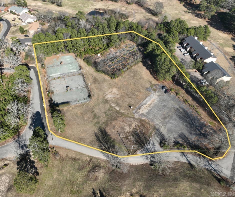 Unlock the potential of this unique commercial property—formerly home to a full-size tennis court complex. The site offers a rare opportunity for redevelopment into a modern tennis or pickleball facility, recreational center, or reimagined for other commercial uses. With ample existing paved parking, the groundwork is already in place for a variety of projects. The courts will need to be resurfaced or replaced, but the location and layout provide a strong foundation for future development. Ideal for investors, sports facility operators, or entrepreneurs seeking a flexible-use property.
