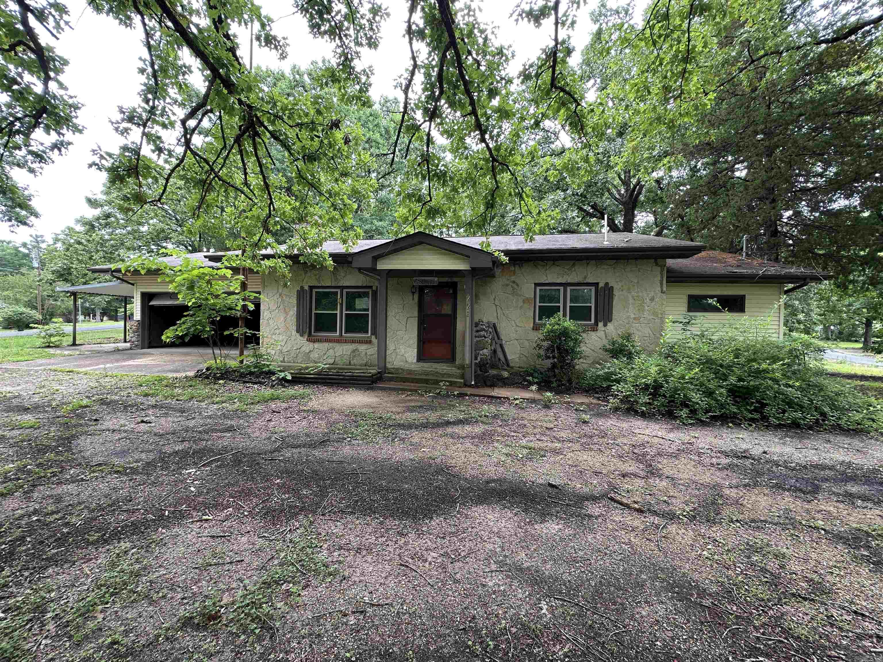 Discover a property with exceptional potential in the heart of Lakeview. Located just minutes from Bull Shoals Lake access, this spacious setting offers the ideal opportunity for anyone looking to create a personalized lake area retreat or investment property. The home sits on a large, usable lot, providing room to expand, garden, or simply enjoy the peaceful surroundings of the Ozarks. The main residence features 3 bedrooms and 2 bathrooms, offering a functional layout with plenty of space to reimagine. In addition to the primary home, the property includes a detached living area equipped with 1 bedroom, a half bath, a living room, and a kitchen, perfect for guests, extended family, or potential rental income. This added flexibility makes the property especially appealing for buyers seeking multi use living arrangements or creative renovation possibilities. A 2 car attached garage provides secure parking and convenience, while multiple storage areas throughout the property!