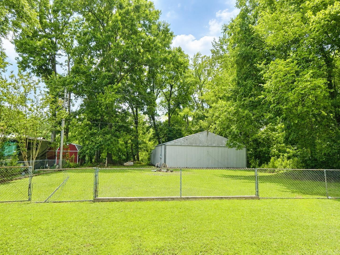Riverfront Property with Airplane Hangar & Landing Strip Access  Rare opportunity to own a riverfront lot with aviation convenience! This fenced property features a massive 40' x 163' airplane hangar and is located directly across the road from a landing strip, making it ideal for aviation enthusiasts or those needing substantial storage space. A septic system is already on the property, though it has never been connected. Enjoy riverfront access, wide-open possibilities, and a unique combination of waterfront living and aviation convenience.
