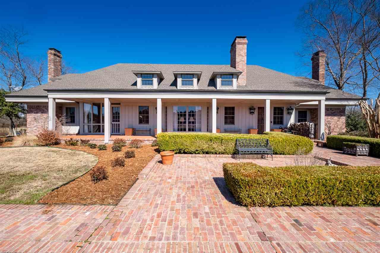 Spectacular Roland Estate situated on approx. 76 beautiful acres. Enjoy the best of everything, handsome ext, fantastic flr plan and stunning setting. Fabulous entertaining spaces and generously proportioned private living quarters. Soaring two story ceilings in entry/living. Elegant formal living and Large family room with hardwoods adjacent the custom kitchen and gorgeous dining. Wonderful sunroom off living. Spacious den. Owners suite on the main level. Pool, pool house, storage, Gated. Call for details!