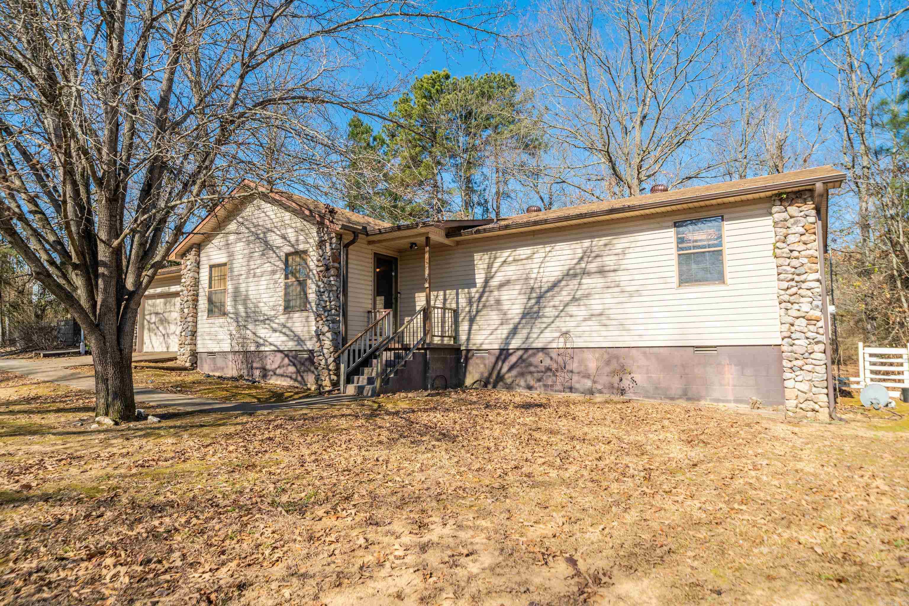 Welcome to this inviting 3-bedroom, 2-bath home ideally located just minutes from the lake. A rare find in the Lake Hamilton School District under $250,000, this property combines comfort, functionality, and an unbeatable location. Inside, you’ll find a bright screened in porch—perfect for morning coffee, relaxing with a book, or enjoying peaceful outdoor views year-round. The spacious backyard offers ample room for entertaining, gardening, or play, while convenient outdoor storage provides space for tools, lake gear, or hobbies. With a new roof and gutters installed last year and a fantastic location close to lake life and all that Hot Springs has to offer, this home is ideal as a full-time residence, weekend retreat, or investment opportunity.