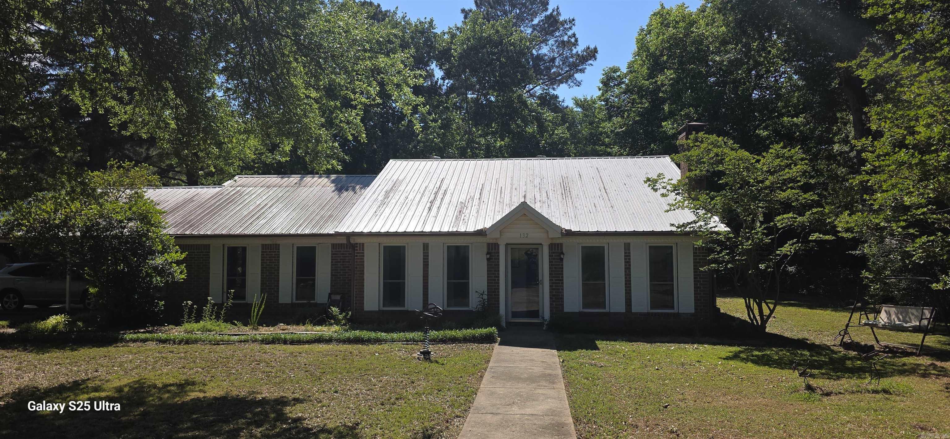 Beautiful home sitting on just under a acre. Property is well established, mature trees, lots of shade, with plenty of room for a growing family and easy upkeep. Oversized master that connects to the large laundry/ office area. Two storm shelters, above and below ground. New septic in Jan. 2024, Zoned Heat/AC. Metal roof around 6 years old.  Small shop w/electric and two additional storage buildings, one with electric. Just outside city limits but not far from either Vilonia or Conway.