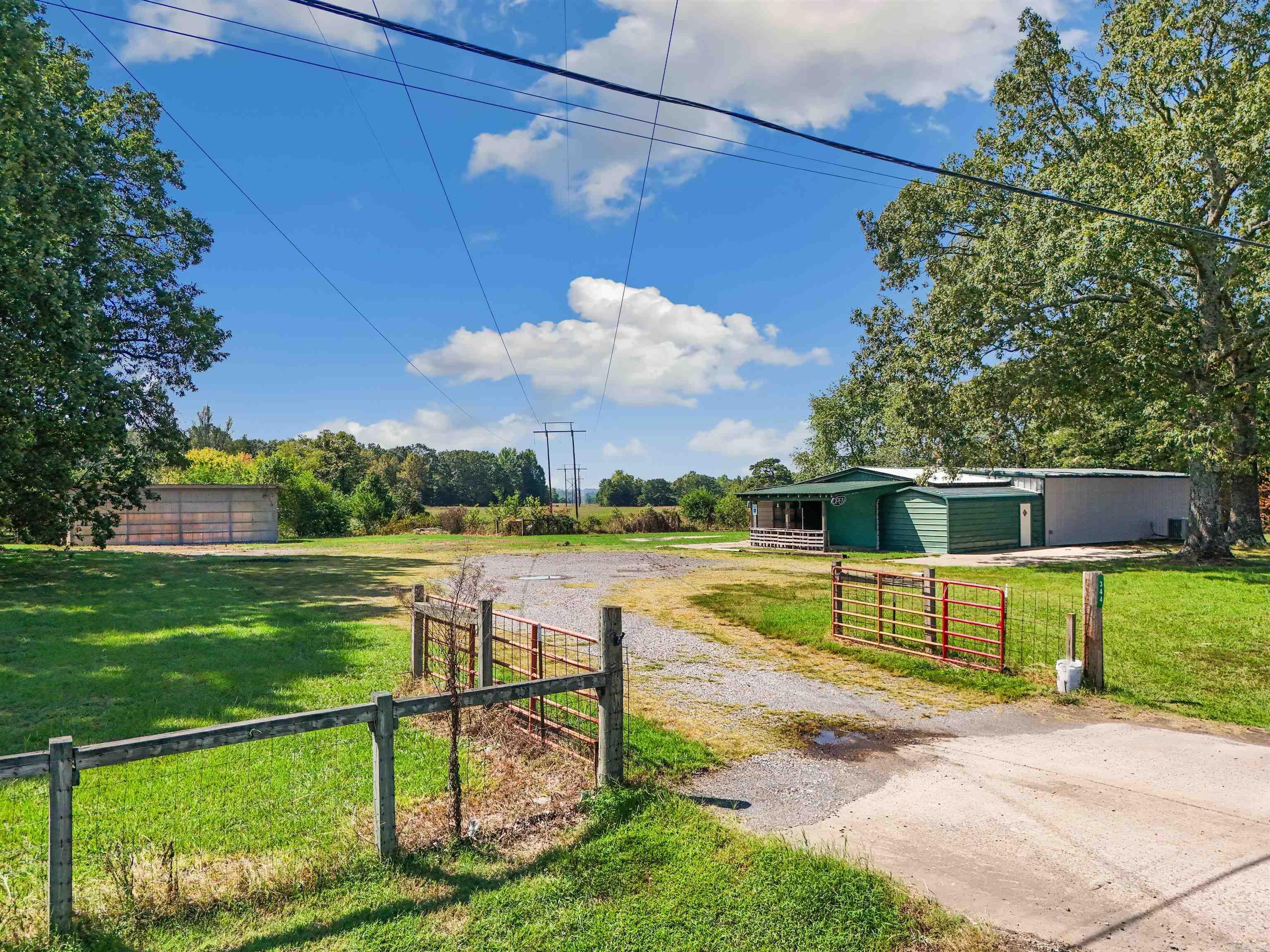 Opportunity awaits! Have you always wanted to open your own business? Maybe a farmstand, flea market, store, or office space? This 3365 sf building is heated and cooled, has a half bath, and a kitchenette, and is right across the highway from the thriving Arkansas Elite Welding Academy. HVAC has routine yearly maintenance.  Building is 60' x 50' and has 10' ceilings. There's also a 18' x 40' pole shed. With over an acre space, there's so many possibilities. Be sure to check out the aerial drone video, and call today to schedule your showing.