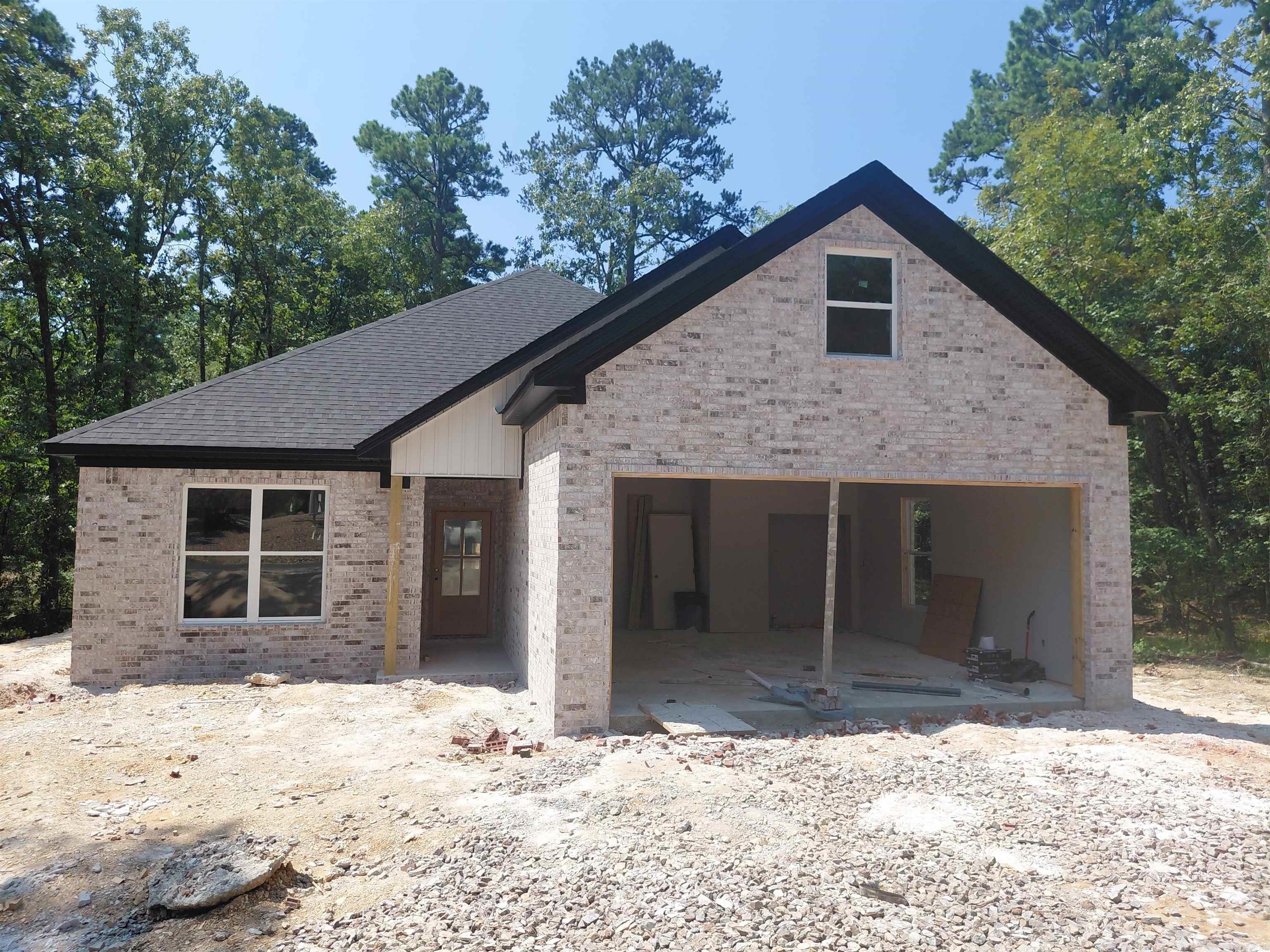 Hard to find New construction under $300,000. This carefully thought out floorplan is perfect for any buyer looking for low maintenance. Features include a Brick and  Vinyl Board and Batten exterior. A lovely covered porch that stretches  across the back of the home, allowing for maximum enjoyment and privacy of your wooded  lot. The interior has a nice flow with luxury vinyl floors throughout. Custom wood Cabinets with soft close, LG appliances and Quartz countertops. 240Sq feet Bonus space (not included in current  sq. footage) perfect for extra storage or future man cave/ craft space or Grandchild dormitory or even a golf simulator, you decide!! Already has electric and prepped for a mini split. If desired can be built out for you. Expected completion late August/early September. Call for colors and tour.