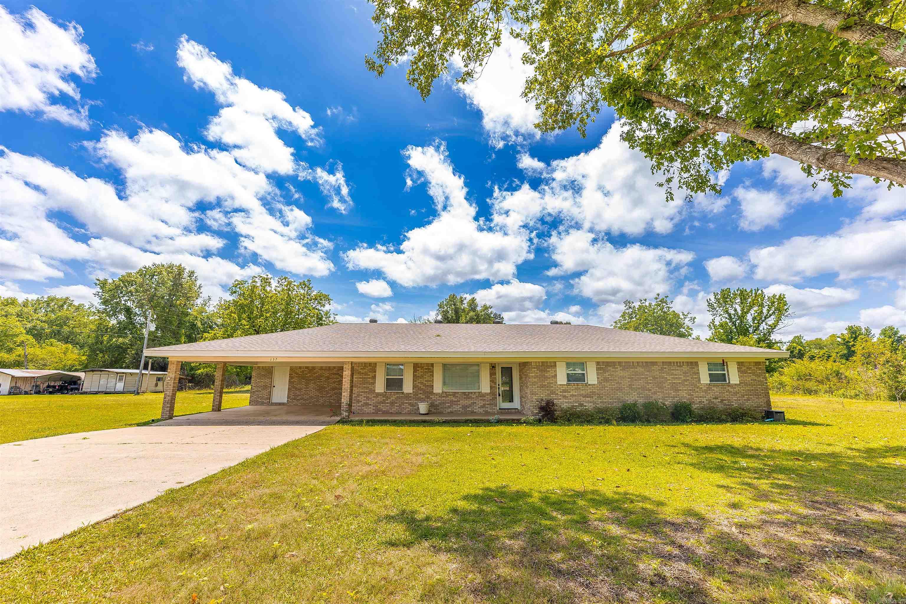 Welcome home to this beautifully remodeled brick property, featuring modern style and timeless durability. Thoughtfully updated with a neutral palette and warm wood accents, this home feels both inviting and refined and full of personality.  The open-concept kitchen and living area is ideal for gathering, centered around a cozy wood-burning fireplace. A flexible office space can serve as a fourth bedroom or craft room.  You’ll appreciate the practical features as much as the aesthetic ones, including a spacious mudroom, laundry room, bedrooms, and walk-in closets. The primary suite is a true retreat, featuring a spa inspired walk-in shower and double vanities.  Step outside to a screened back patio overlooking a partially fenced yard. A shop with slab foundation & electricity provides valuable extra space for storage and hobbies.   Recent upgrades include a new roof and water heater (2025), whole-home water filtration system, and a direct generator meter interlock for added peace of mind.  Located in the desirable Harmony Grove School District, this home offers beautiful finishes, functional spaces, and a location that’s hard to find. A rare opportunity you don’t want to miss!