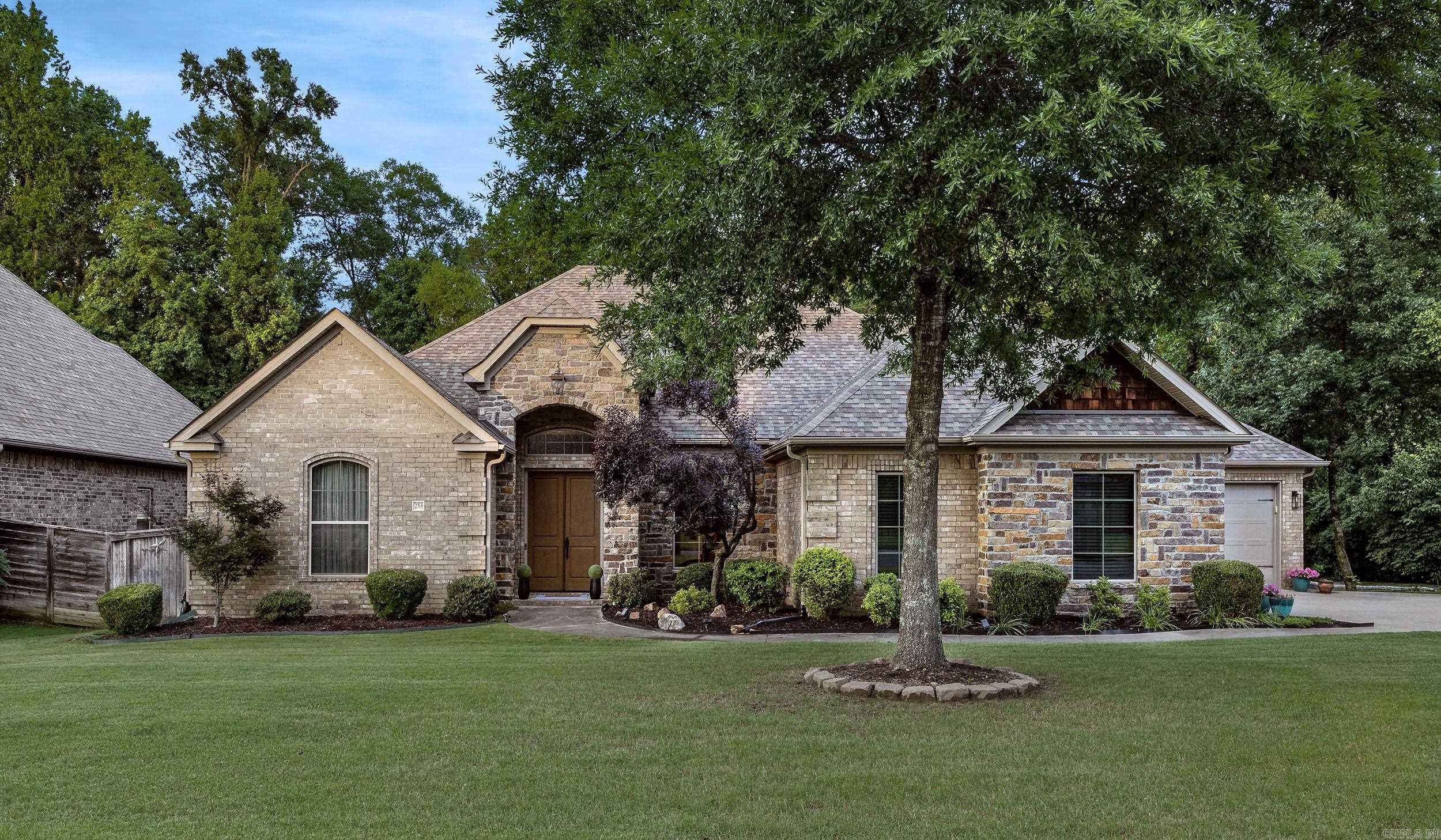 A RARE find! Located on a level lot with a private backyard backing to a dedicated green space! Gorgeous and inviting, this 5 bedroom, 3.5 bath home has space for everyone on one level! Open plan.  Double front doors lead to large foyer, formal dining area and spacious living space w/10' ceiling.  Living area has a gas log fireplace and wall of windows overlooking covered patio and backyard.  Kitchen is open to family room with oversized breakfast bar, granite countertops, gas 5 burner cooktop, double ovens, microwave, abundant cabinets & countertop space, large pantry and spacious breakfast area.  Primary bedroom is separate from others.  Primary bathroom has dual vanities, tile shower, tub and huge walk-in closet with 3 built in chest.  Three bedrooms and two baths off hallway.  The fifth bedroom could be an office, playroom, or second living space and is located off the kitchen area. Relax, entertain or just enjoy the privacy of the wonderful huge, covered patio with tv cabinet and woodburning fireplace.  The large, level yard is fully fenced with wood side fencing and ornamental fencing in back and backs to wetland preservation area.  3 car garage & sprinkler system.  Must see!