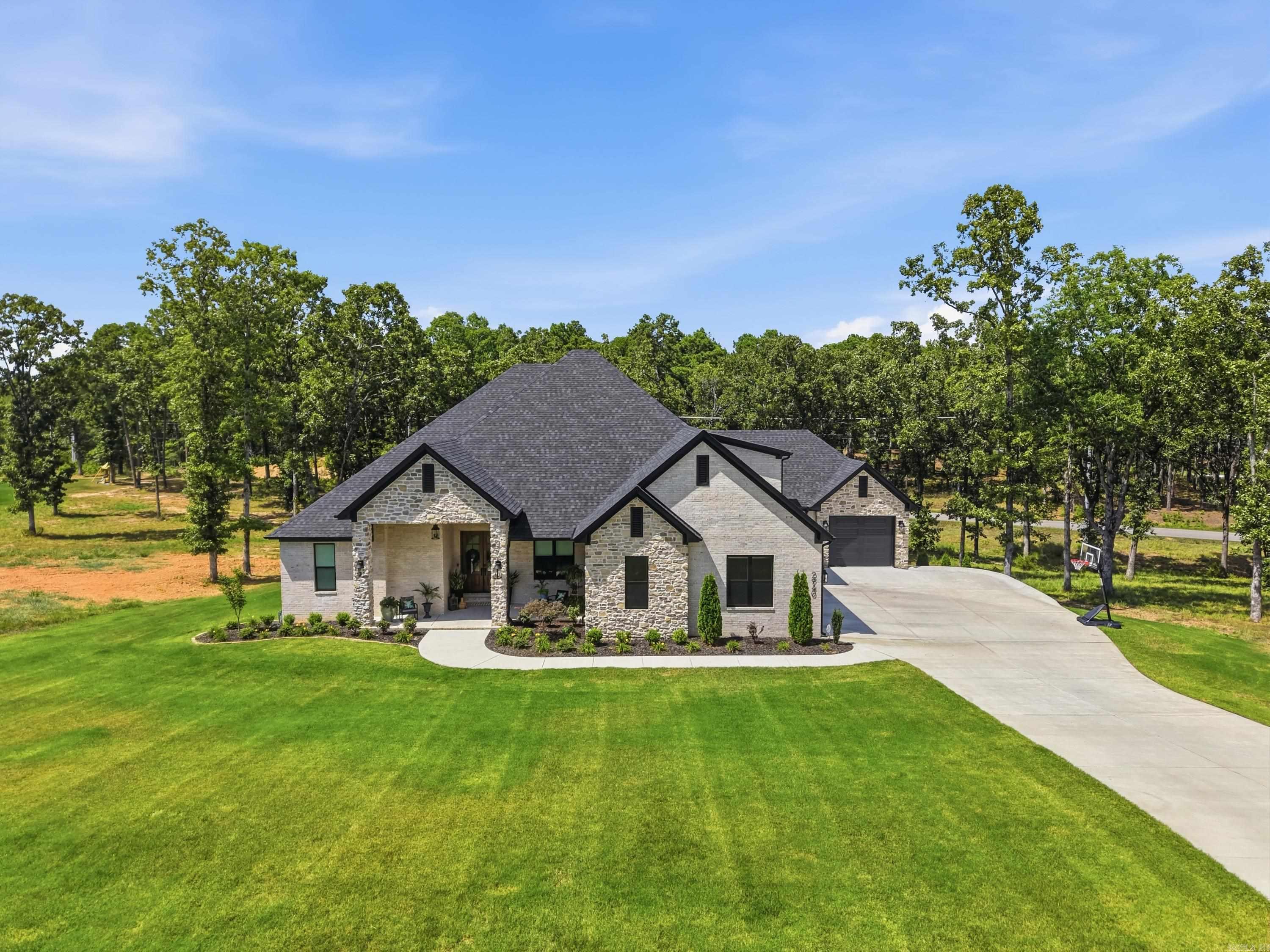 Stunning 5 bed 3 1/2 bath custom home in Orchard Hill situated on almost an acre with a beautiful open floor plan. The welcoming front porch leads into a gorgeous foyer w/office just off the entry. The foyer opens into a spacious living area featuring a fireplace focal wall and views of the backyard. The kitchen is a chef’s dream w/quartz countertops, large center island w/bar seating, gas cooktop, wall oven, convection microwave & separate walk-in pantry. The primary suite offers a spacious bedroom with a spa-like en suite w/custom tile walk-in shower, separate tub, double vanities w/custom cabinetry & large walk-in closet connected to the laundry room. Downstairs also includes 3 additional bedrooms w/great closet space, Jack & Jill bathroom w/beautiful tile shower. Upstairs you will find a fifth bedroom, half bath & large bonus/media room. The screened-in back porch has a fantastic outdoor kitchen w/granite countertops, sink, refrigerator & grill hookups. Three car garage, beautiful landscaping & spacious yard.