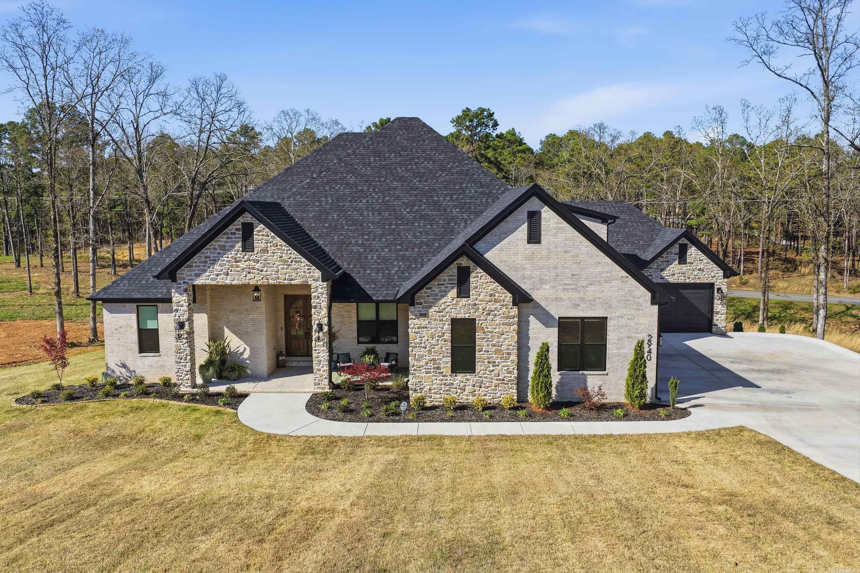 Stunning 5 bed 3 1/2 bath custom home in Orchard Hill situated on almost an acre with a beautiful open floor plan. The welcoming front porch leads into a gorgeous foyer w/office just off the entry. The foyer opens into a spacious living area featuring a fireplace focal wall and views of the backyard. The kitchen is a chef’s dream w/quartz countertops, large center island w/bar seating, gas cooktop, wall oven, convection microwave & separate walk-in pantry. The primary suite offers a spacious bedroom with a spa-like en suite w/custom tile walk-in shower, separate tub, double vanities w/custom cabinetry & large walk-in closet connected to the laundry room. Downstairs also includes 3 additional bedrooms w/great closet space, Jack & Jill bathroom w/beautiful tile shower. Upstairs you will find a fifth bedroom, half bath & large bonus/media room. The screened-in back porch has a fantastic outdoor kitchen w/granite countertops, sink, refrigerator & grill hookups. Three car garage, beautiful landscaping & spacious yard.