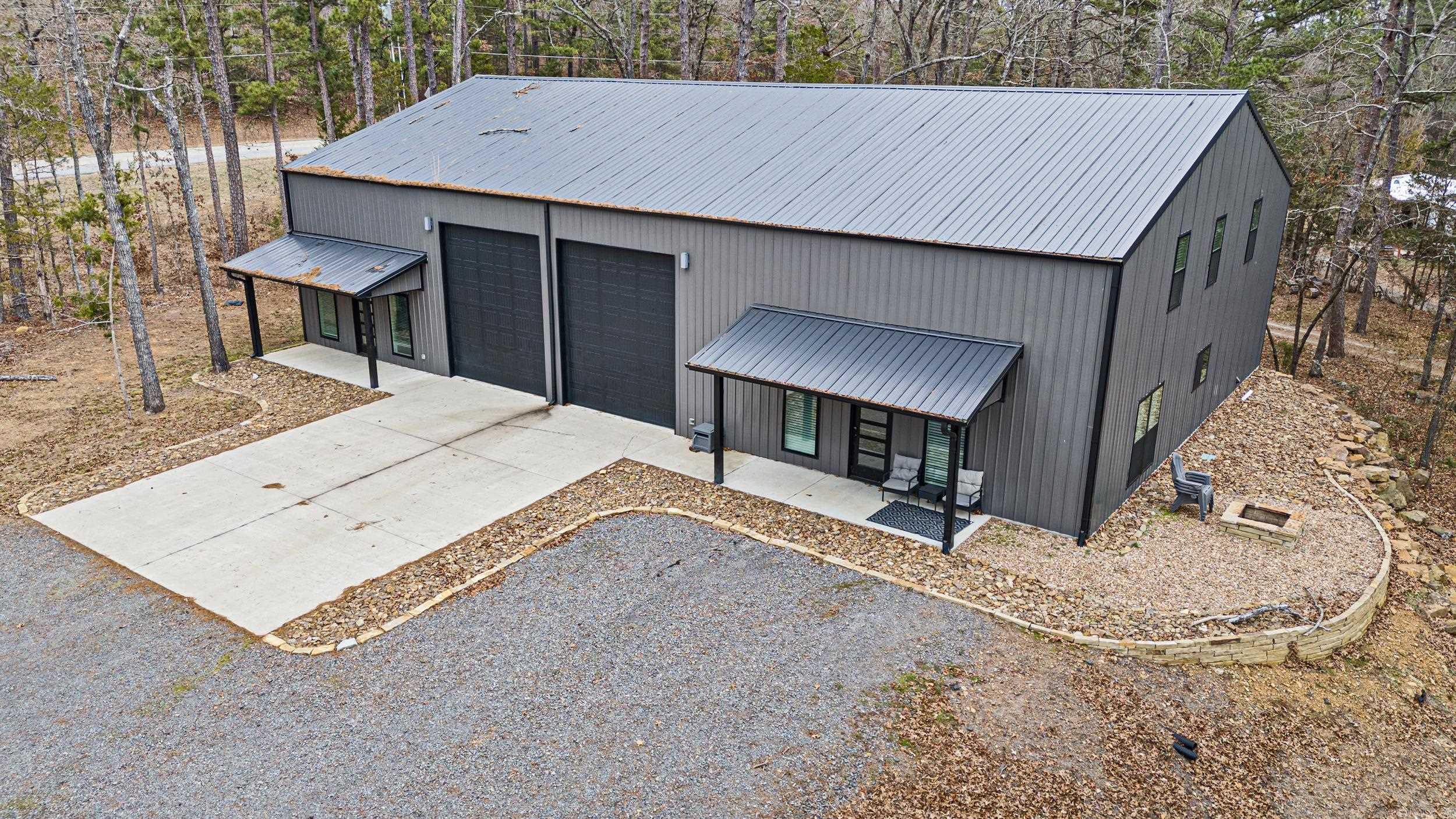 This stunning 3,500-square-foot lake home, located less than 2 minutes from Greers Ferry Lake, offers modern living and easy access to outdoor adventures. The main house features five spacious bedrooms, two baths, and a large living area with breathtaking lake views. The primary bedroom is on the first floor for convenience. The gourmet kitchen boasts high-end appliances, an island, and ample counter space.  The attached guesthouse includes two bedrooms, two baths, and a spacious living room with lake views, perfect for visitors. Both the main house and guesthouse feature clean, modern finishes.  A super-large garage provides ample space for boats, ATVs, and pickleball equipment, catering to an active lifestyle. The property is perfect for full-time living, a weekend getaway, or as a nightly rental.  Located close to Greers Ferry Lake, you'll enjoy easy access to boating, fishing, and water activities. Plus, it's an easy commute to Conway and Little Rock, offering the best of lakefront living with city convenience. This home blends comfort, luxury, and outdoor fun!