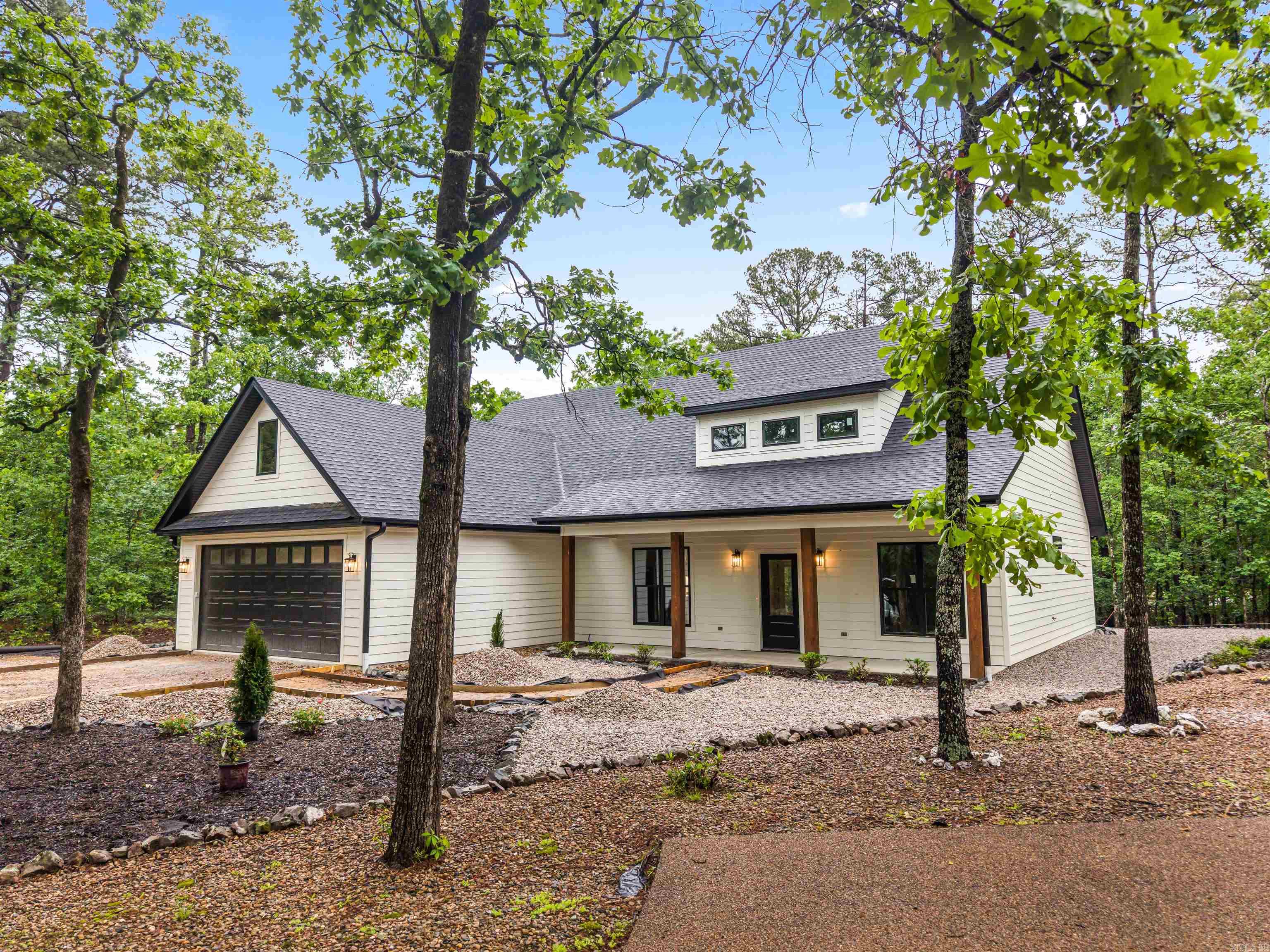 Brand New 2026 Construction. Welcome to this beautifully crafted 3-bedroom, 2.5-bath home located in the highly desirable Fountain Lake School District near the Glazypeaux gate of the Hot Springs Village. Thoughtfully designed for modern living, this brand-new construction offers both style & function with upscale finishes throughout. Step inside to an open-concept floor plan that flows seamlessly through the living, kitchen, and dining areas—perfect for entertaining or everyday life. The spacious living area features an electric fireplace that adds both charm & comfort. The kitchen is a standout, equipped with a large slab granite island & abundant counter space.  The kitchen/dining combo allows for effortless meals & gatherings. The split-bedroom layout ensures privacy, with primary suite offering a serene retreat. Enjoy his-and-her vanities with granite countertops, a luxurious oversized walk-in shower, & custom walk-in closets complete the suite. More pictures to come. Call today to schedule your private showing!