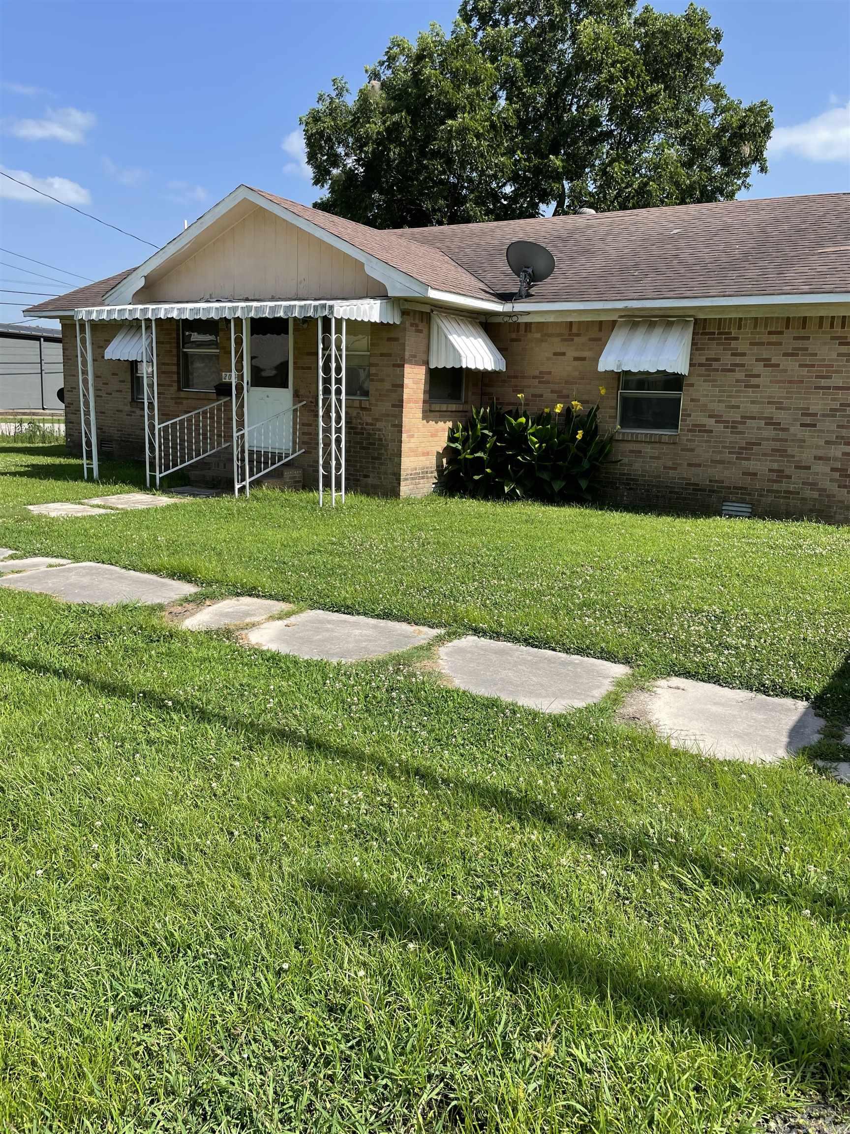 Brick home 2 bedroom 2 bath large corner lot 2 car carport  This home has a great rear carport with extra storage which has access to the kitchen and the huge laundry room with 2 great family areas. front porch leads to a large living room area which leads to another large room in the rear of the home whish has sliding glass doors. Large bedroom with bathroom close at hand to both bedrooms. Property has a large rear yard area. Yard has access to both side street and 4th street.