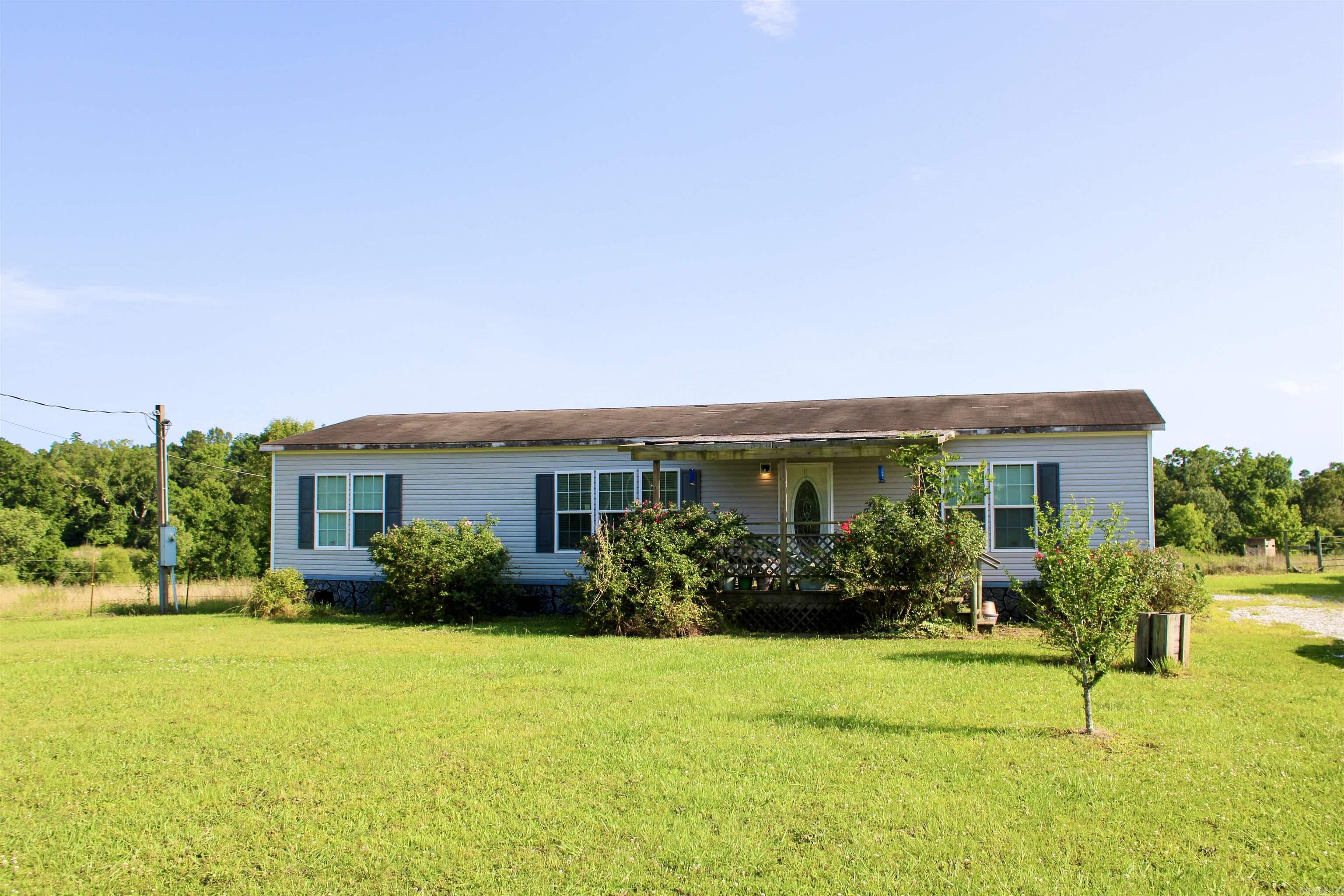 Comfortable living in a country setting is what you will find with this property. It's perfect for a full-time residence or hunting retreat with no shortage of wildlife. Very well-maintained manufactured home boasts a functional open floor plan. It has an office or possible nursery room. There's 26+/-  fully fenced in acres ready for your livestock, atv's or gardening. It offers convenient access to some of Southwest Arkansas's most popular destinations like Crater of Diamonds State Park, Lake Greeson and the Little Missouri River. There's a couple of options. Property can be purchased with or without home.