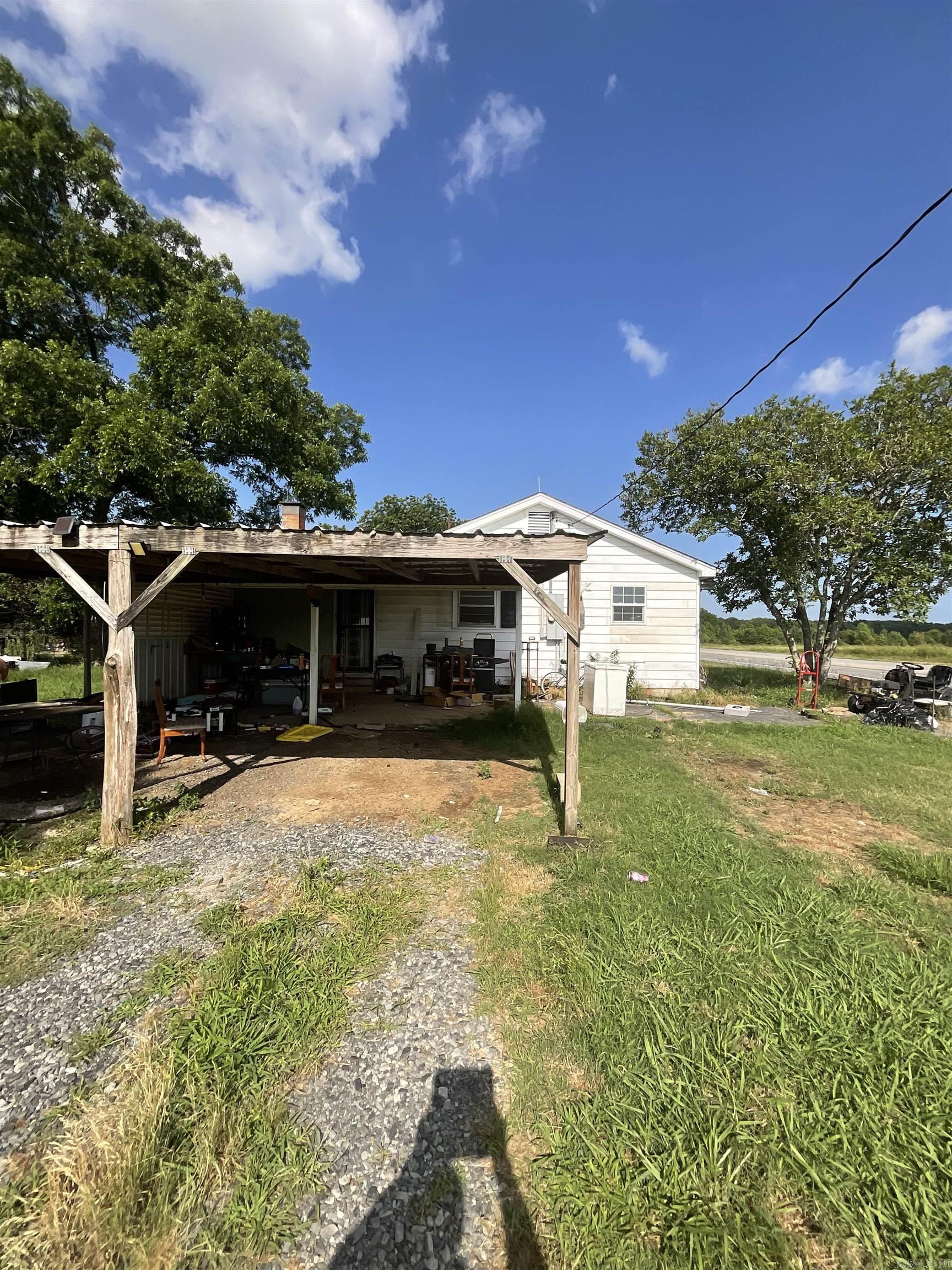 Enjoy country living with mature trees, open space, carport, and outbuildings. Plenty of room for animals, gardening, equipment, or future expansion. Conveniently located on Hwy 64 W with easy access to town. Great opportunity for an owner-occupant, investor, or anyone seeking acreage and potential. No seller property disclosure. Buyers are encouraged to measure lot size and square footage for themselves.