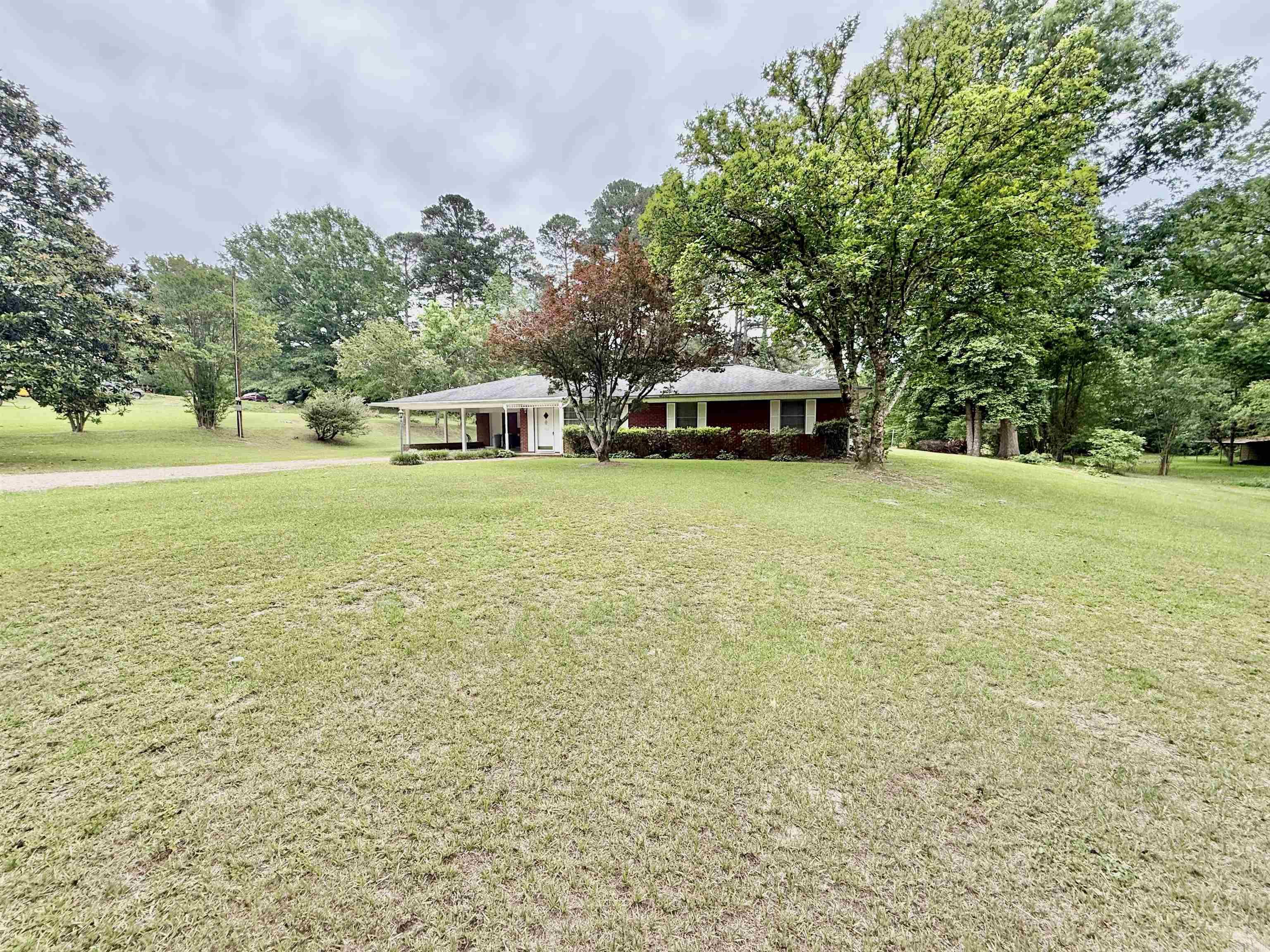 Three bedroom, two bath property located just outside the city limits on a spacious lot where you can enjoy beautiful golf course views. This property features a functional layout with a mudroom and laundry room conveniently located off the carport and kitchen. The refrigerator will remain with the property. Inside you will find both a living room and a den, along with a fireplace located in the dining room that adds warmth and character. The property also backs up to the country club for a peaceful setting. Enoy the views on your covered back porch! Like golf? Even better, join the Camden Country Club and drive straight on the course for a round or two!!