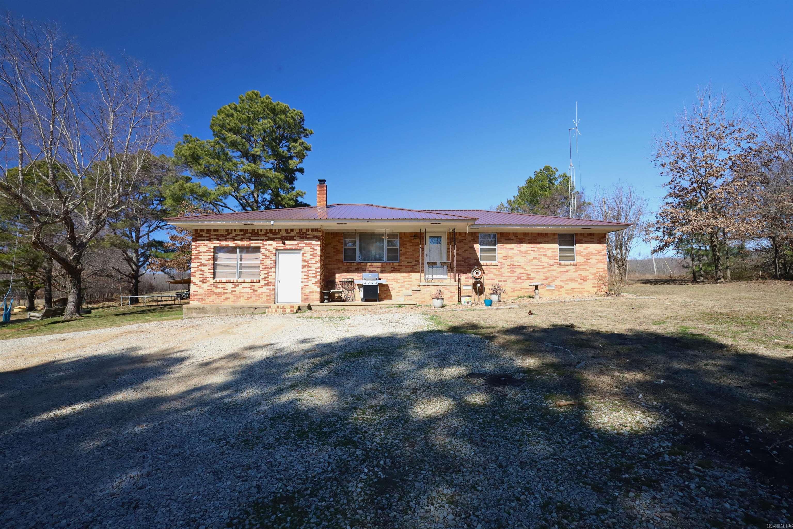 Located just outside Rector, this ±76-acre working cattle property offers a functional setup suitable for both new and experienced operators. The land is cross-fenced and equipped with a working cattle corral featuring an alley and tub, walk-down access to a Priefert chute, cattle guards for pasture access, a horse pen with tie-out, three barns/outbuildings (storage, workshop, and cattle/feed/equipment use), and two well-maintained stocked ponds, one with a dock.  Abundant wildlife including deer and turkey. The brick home offers 3 bedrooms, 2 bathrooms, approximately 1,600+ square feet, mudroom entry, and a durable metal roof. Septic system is approximately 4 years old, and HVAC is approximately 9 years old. Property has access to rural water and fiber internet. A detached shed with lean-to provides additional space for ATVs or equipment. Situated in the Rector School District and conveniently located about 15 miles from Paragould. Property is 6 miles from both Marmaduke and Rector Schools Farm may be purchased as a turn-key operation including cattle and hay equipment. Seller can also provide contact information for current hay field landlord