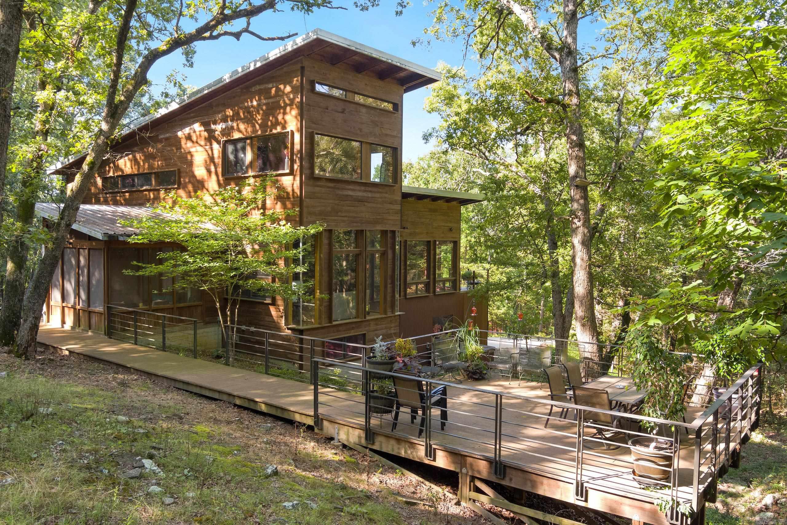 Welcome to one of the most one-of-a-kind properties in the Ozarks. If I were to say this place, had it all, I think it would be an understatement, but truly, this property has something for everyone. Being just minutes from Elkins and just a short drive to Fayetteville, but with all the seclusion and privacy of any place in the Ozarks. This luxury rural oasis custom home is a rustic contemporary architectural masterpiece that will not disappoint.  With three levels that offer 4 bedrooms and 3.5 baths.