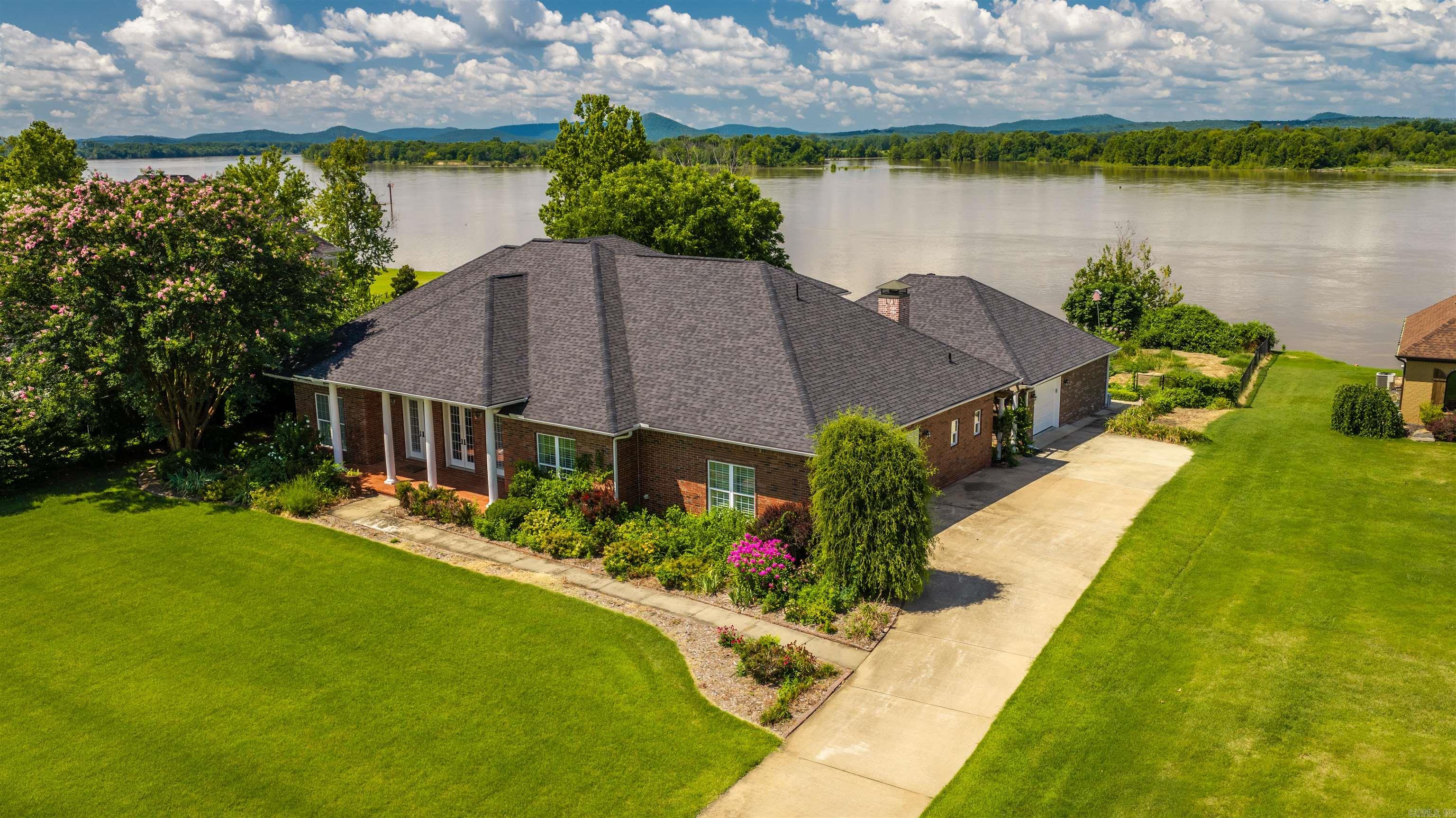 Rare Riverfront Opportunity! Experience timeless elegance in this exceptional steel-framed 3,879 sq ft home with beautiful Arkansas River views and a floor plan designed for both everyday living and entertaining. The main level features a luxurious primary suite, an additional bedroom and full bath, formal living and dining rooms, a spacious family room open to the kitchen, a large laundry room, and a half bath. Upstairs offers two bedrooms, a full bath, a cozy den, two versatile bonus rooms, and a private balcony. Step outside to an expansive covered patio overlooking the backyard and breathtaking Arkansas River. A detached third-car garage includes a finished garden room/cabana with countertops and a private bath, perfect for entertaining, hobbies, a home office, or guest space. You will also enjoy your fenced garden, generator and so much more! **Best of all, this riverfront property is located outside the floodplain and does not require flood insurance** Riverfront homes like this rarely come available. Don’t miss this unique opportunity to own one of Central Arkansas’s most desirable waterfront properties.
