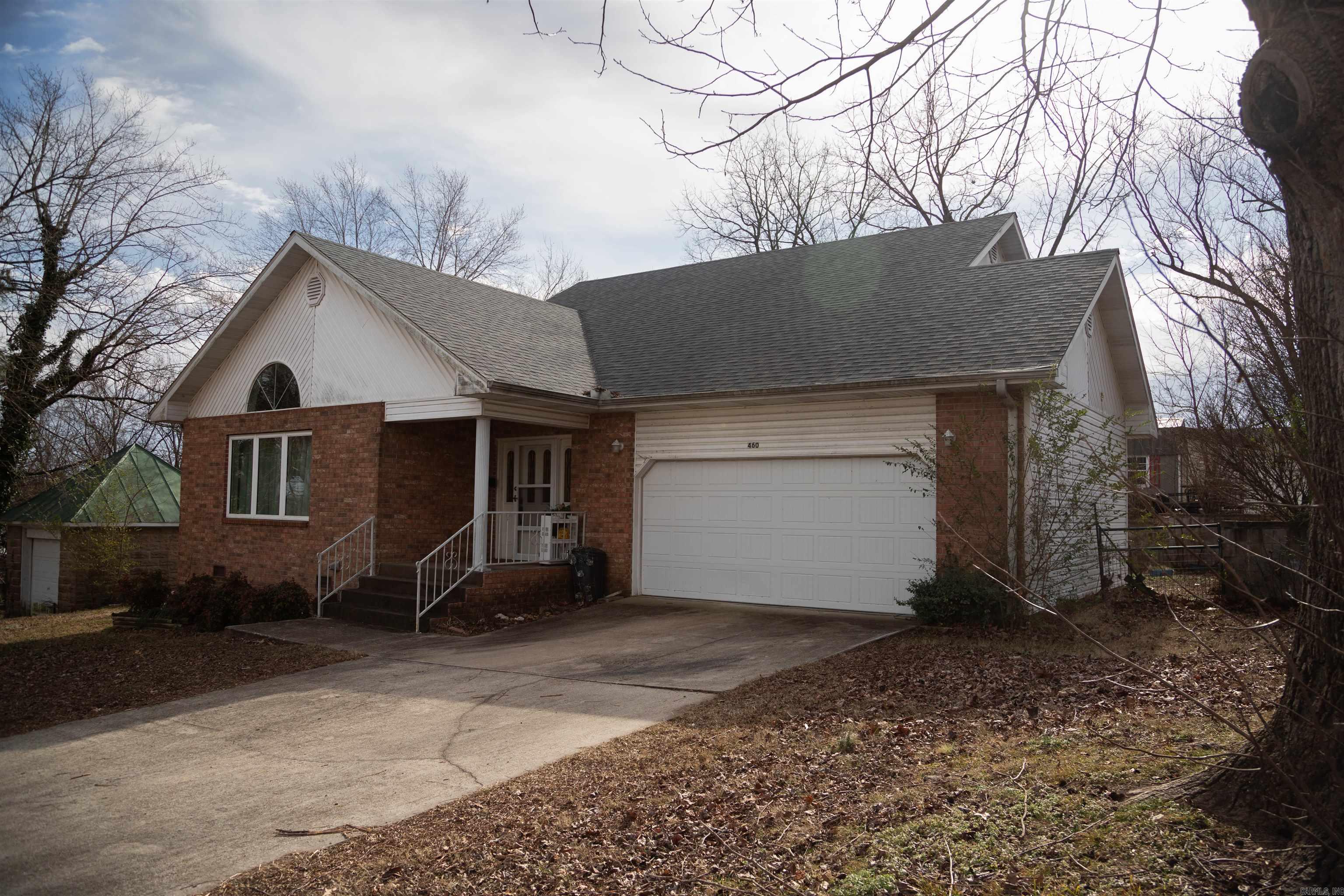 Enjoy comfortable living and small-town charm in this well-maintained home set on a large corner lot near the Spring River.Three-bedroom, two-bath home with a brick front exterior located on a large corner lot in Mammoth Spring. The living room features a vaulted ceiling, providing an open and spacious feel. Home includes an attached garage and storage building for added utility. Conveniently situated near the Spring River with easy access to town amenities and outdoor recreation. Attractive curb appeal in a desirable location.