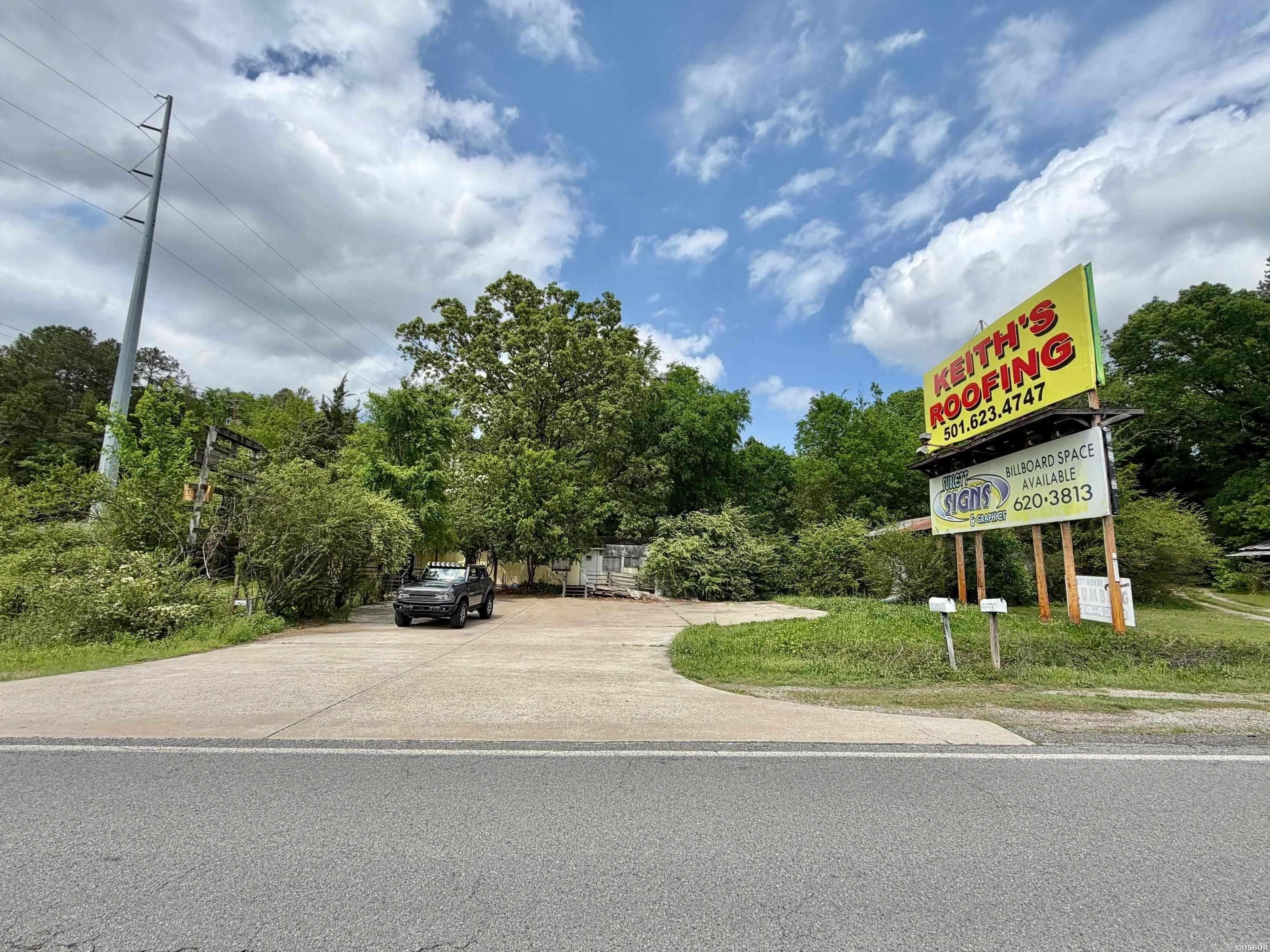 Unique mixed-use opportunity with over an acre of land and 300+ feet of prime frontage along Highway 70 (E. Grand Avenue). Property features a 2-bedroom, 1.5-bath residence suitable for owner-occupancy or rental income, along with multiple outbuildings offering additional storage or redevelopment potential (three in poor condition). High-visibility location with steady traffic flow makes this an ideal candidate for commercial use, live/work setup, or investment hold. Existing billboard lease provides supplemental income. Excellent accessibility and exposure in a growing corridor.