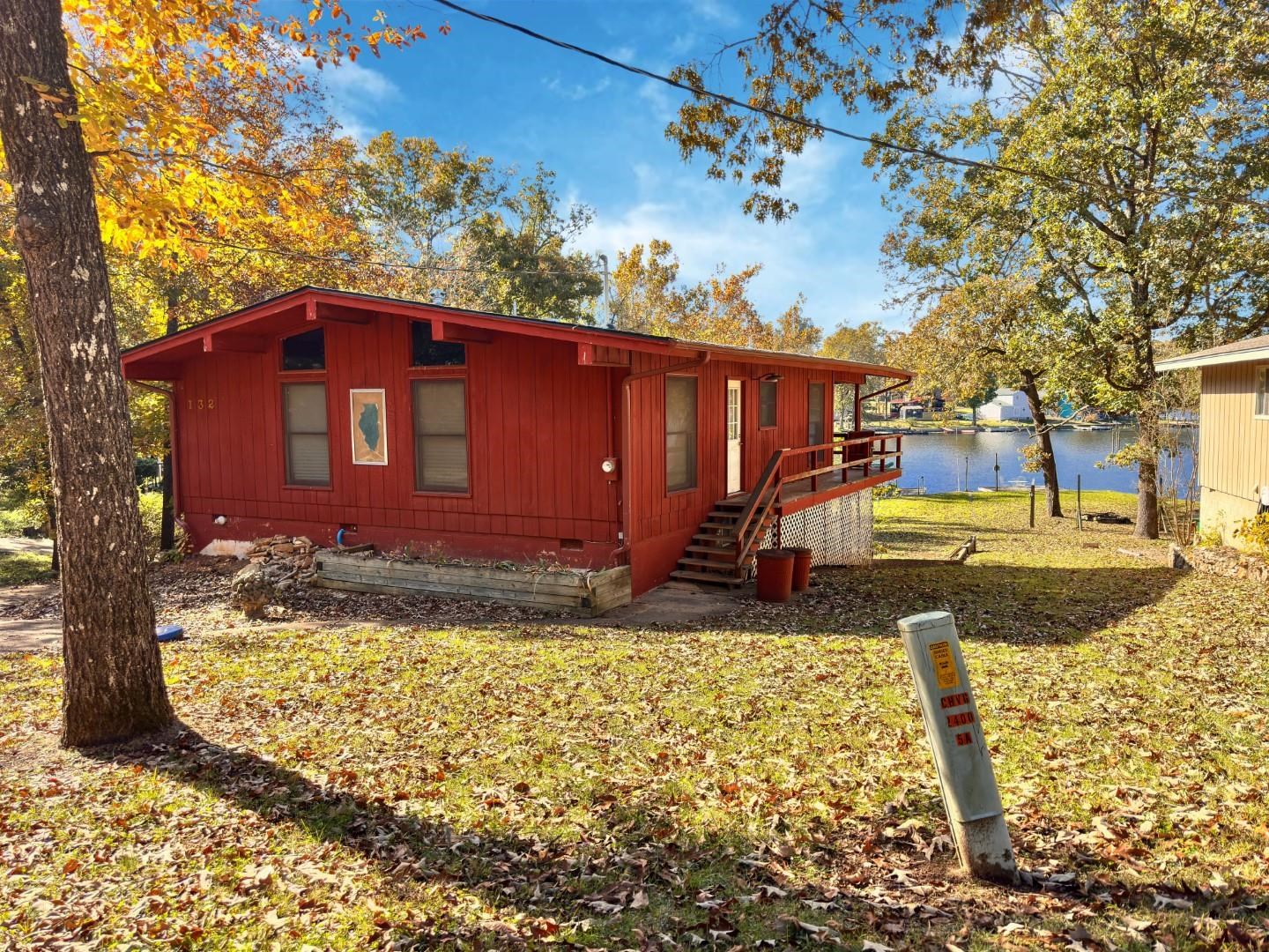 Imagine owning your own piece of paradise with this charming Lake Sequoyah Lake Front Cabin. Set on a beautiful, level lot, this property offers the perfect foundation for a stunning retreat. The cabin features 2 bedrooms and 2 bathrooms within 1,089 sq ft of heated and cooled space. While it's in need of some TLC (tender loving care), this is your chance to customize and create the lakefront dream you've always wanted! Below the main level, you'll find an unfinished basement space, ideal for storing all your lake toys, setting up a workshop, or expanding your living area. With its prime location and excellent features, this cabin is a great investment—whether you're seeking a personal weekend getaway or a lucrative vacation rental. Don't miss this opportunity to capitalize on a fantastic lakefront investment!