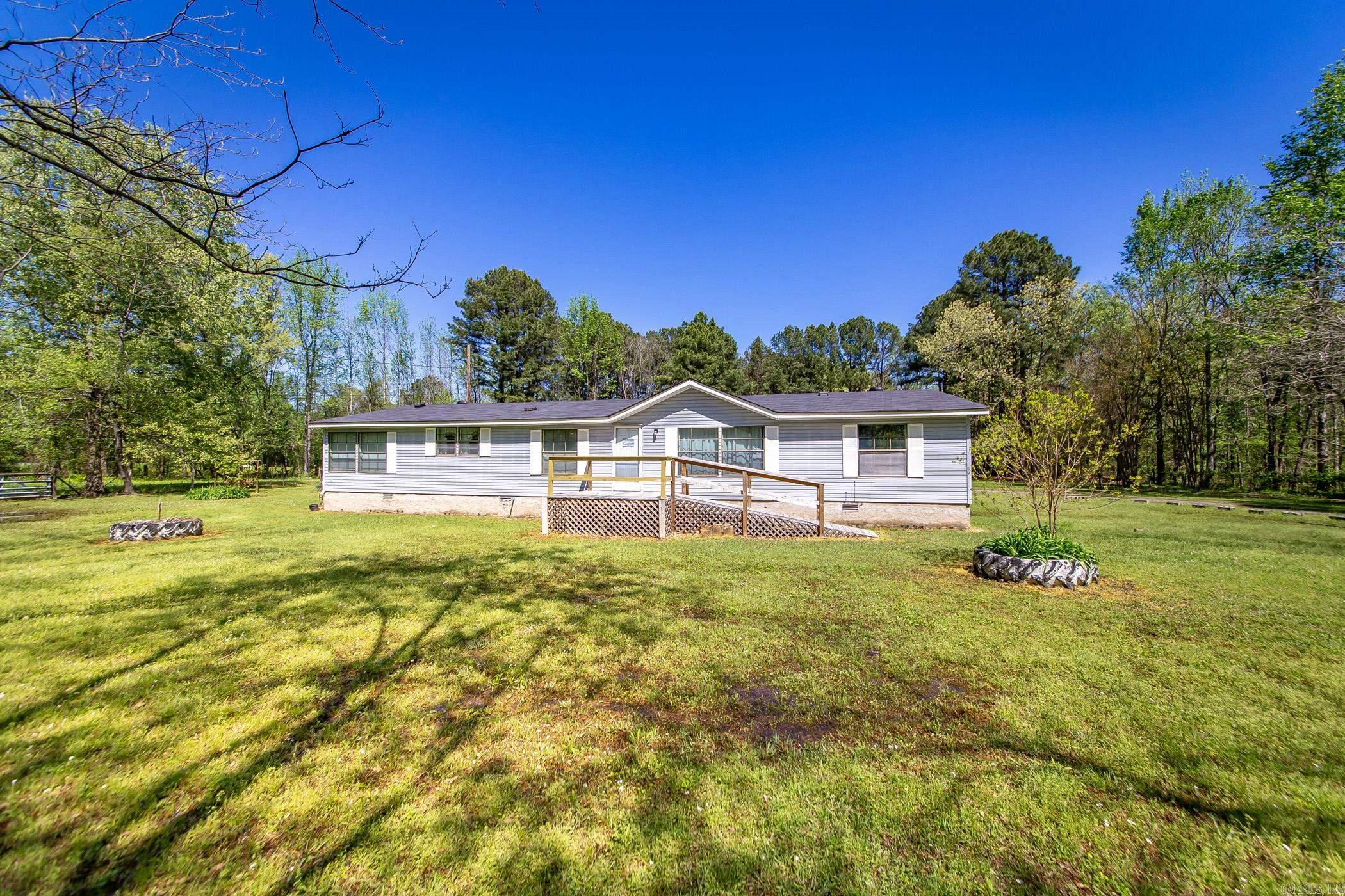 Country living at it's best!  This one owner mobile home sits on 3 acres.  There is a 400 sqft shop has electric and new roof.  Fully fenced in the county, but close enough to Interstate 40 to get anywhere quickly.  This home has a split floor plan, two living areas, formal dining area and a breakfast nook.  New roof, new central heat and air with transferrable warranty.  Lots of pecan trees, a fig tree and a Kieffer pear tree.  Big kitchen with lots of natural light.  You have got to check out the primary bedroom with oversized closets and the shower of your dreams.  This is one you don't want to miss.  Sqft. Approx. Measuring encouraged.